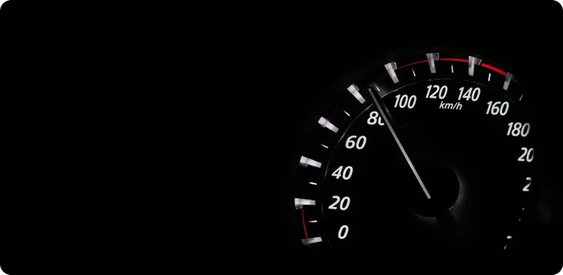 Car speedometer showing a speed of approximately 85 km/h on a black background.