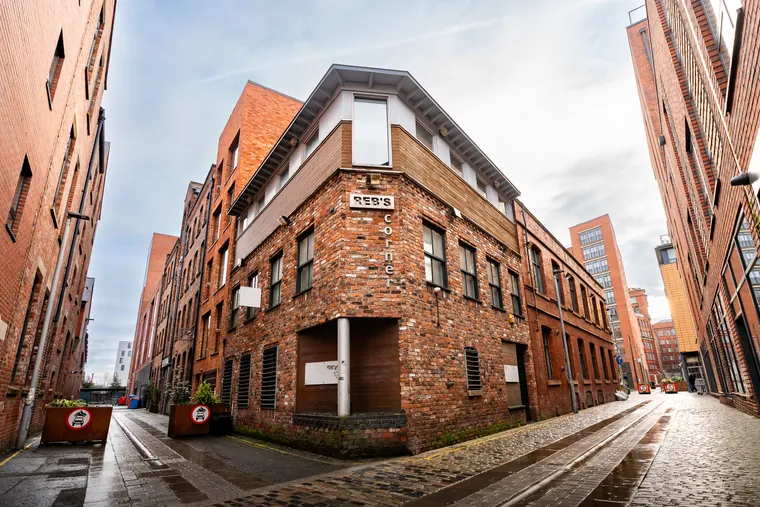 New Office graphic showing Leadly HQ, a red-brick building in Ancoats, Manchester