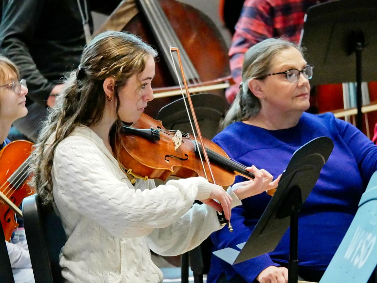 A violist reading in the adult orchestra