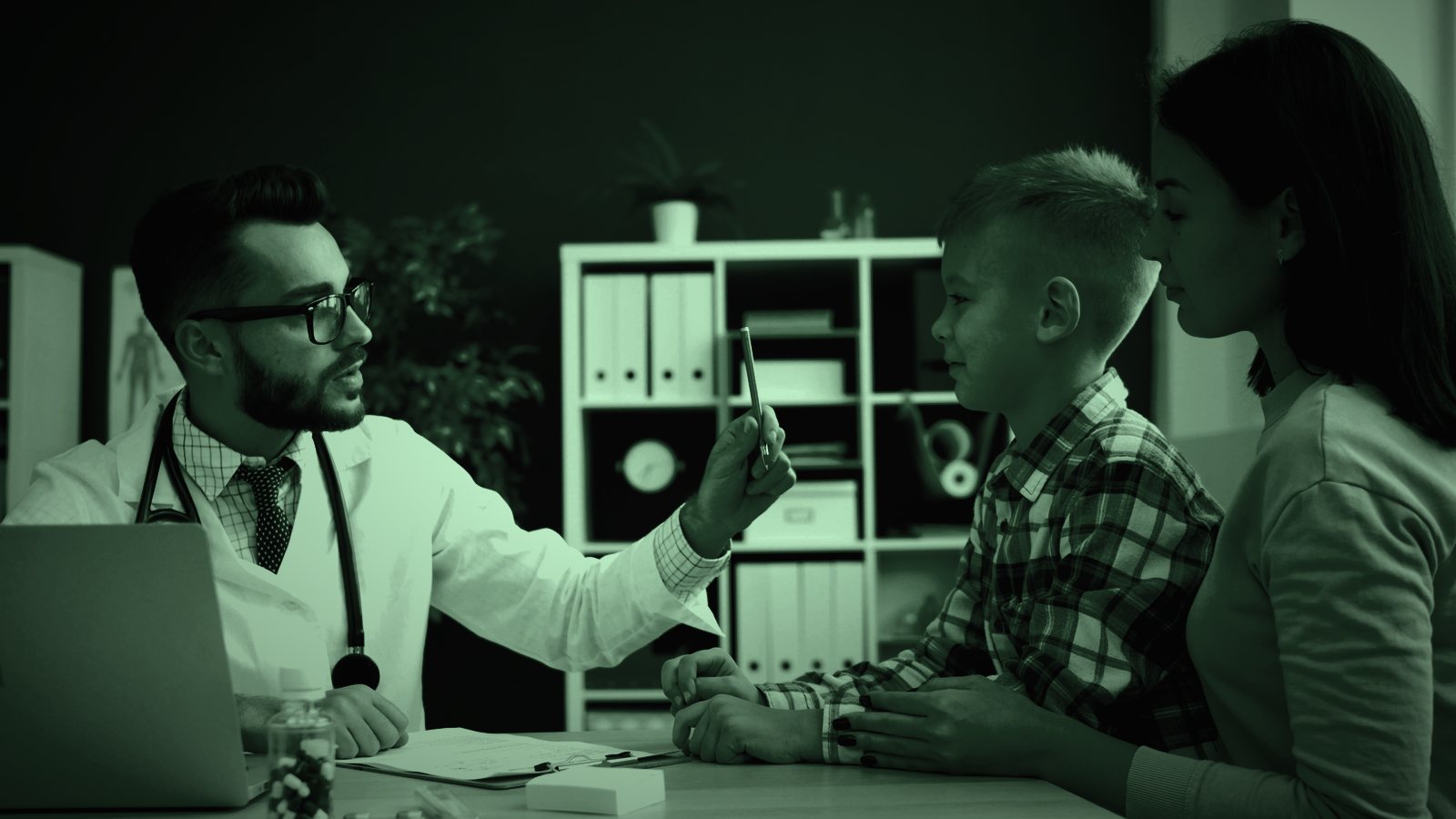 Doctor talking with a parent and child in a clinic, in dark green tones