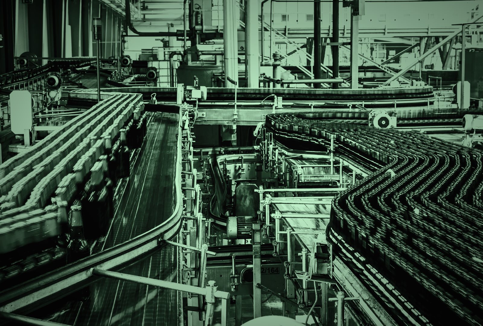 Automated bottling line in a manufacturing plant, in dark green tones