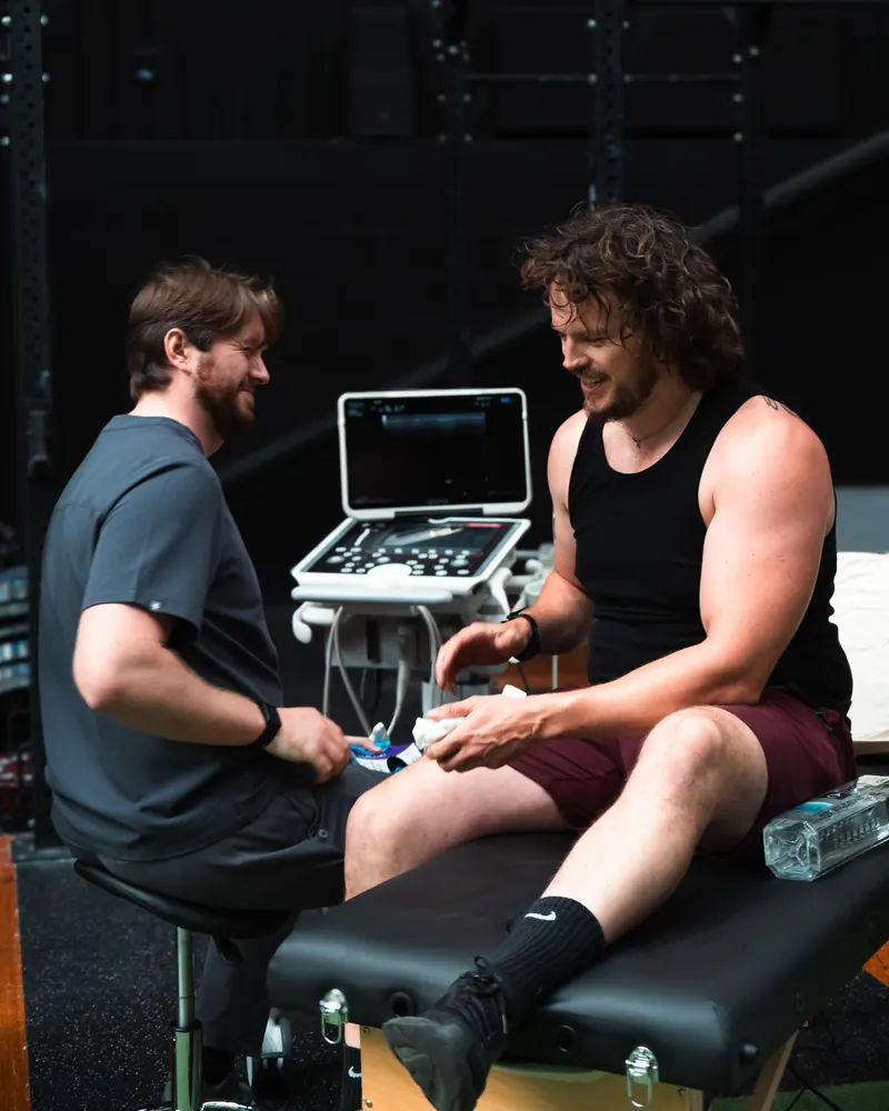Ultrascan clinician chatting with a client after a scan at Empowered Fit