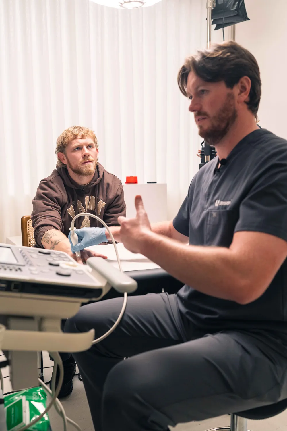 Ultrascan sonographer performing an ultrasound scan on a client's hand