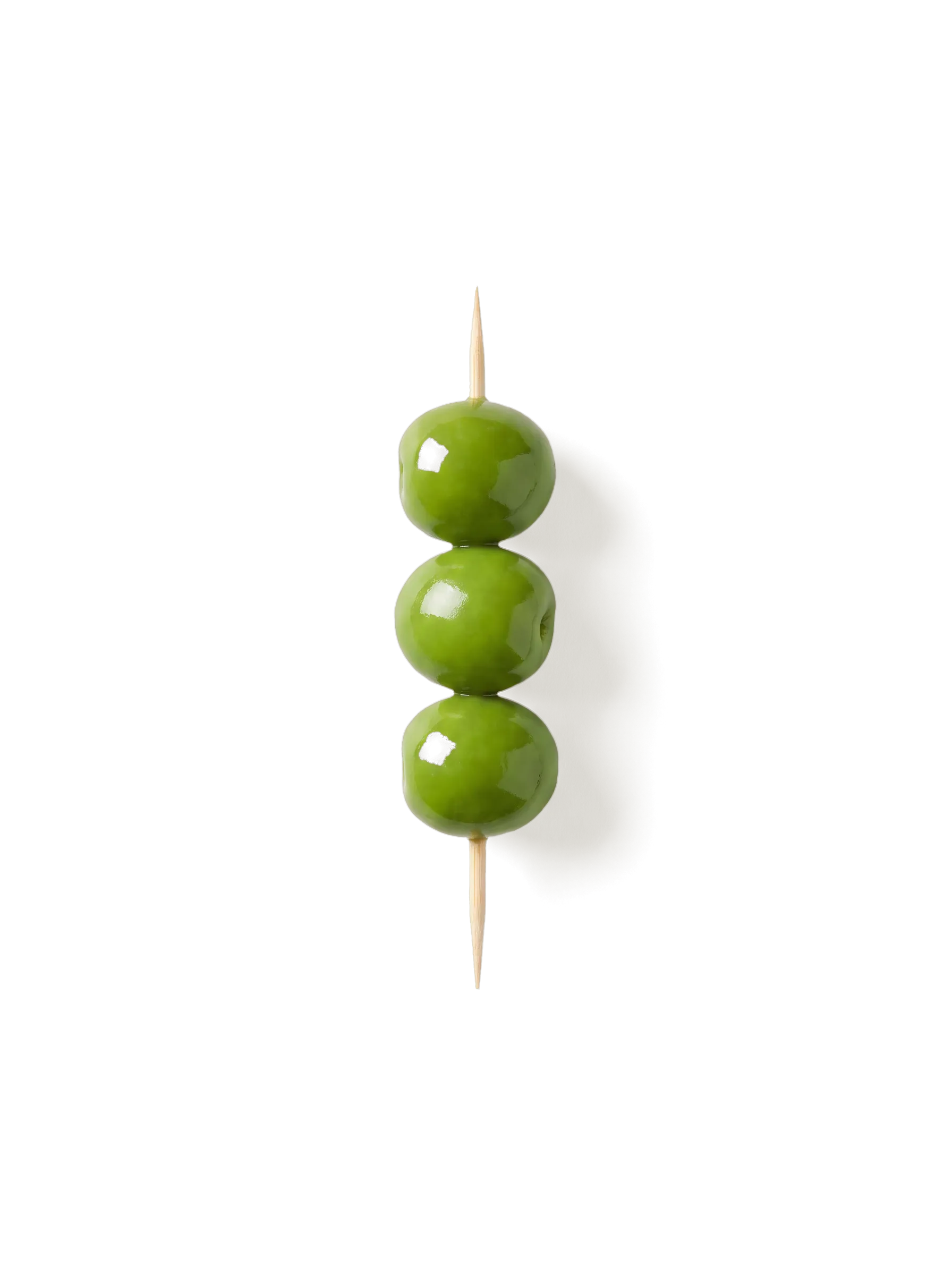 Three Castelvetrano olives on a wooden cocktail pick