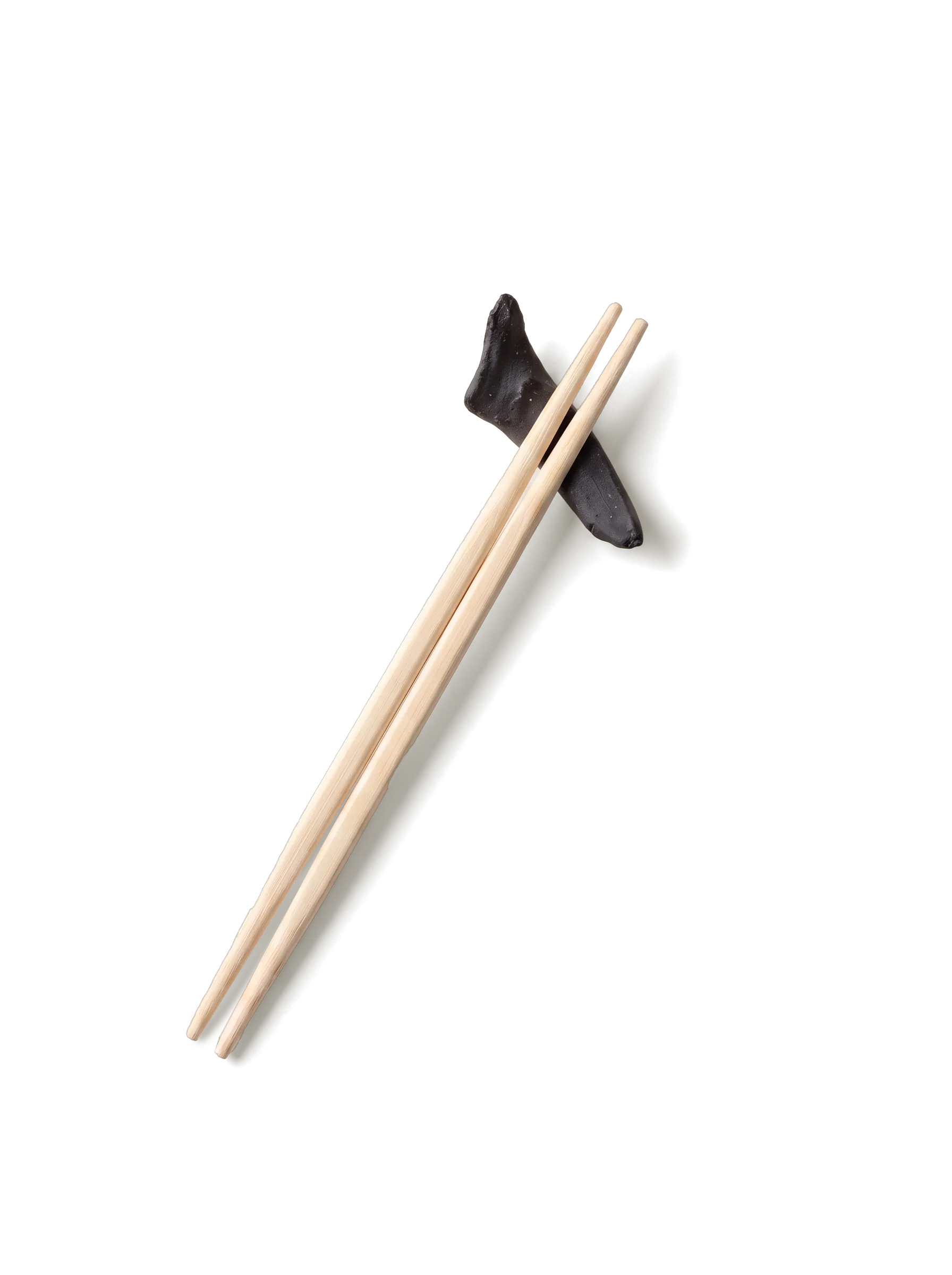 A pair of pale wooden chopsticks on a black ceramic rest