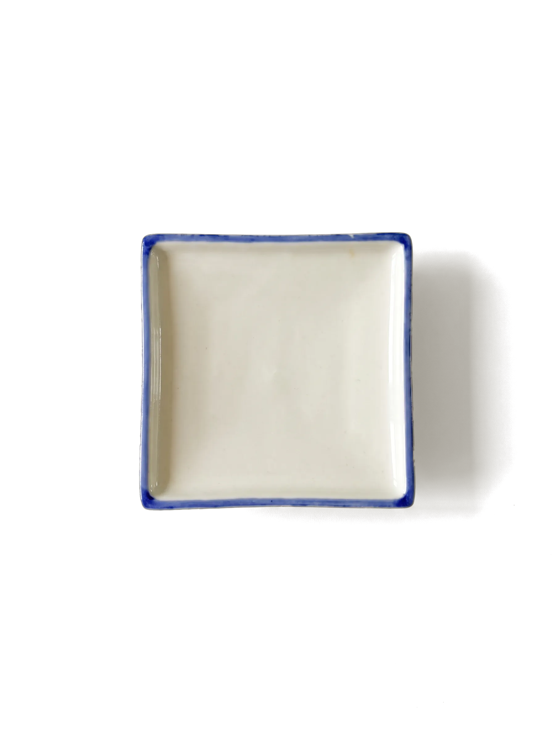 A square blue-and-white Japanese porcelain dish, seen from above