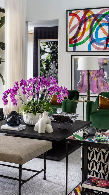 Living room with orchids and colorful framed art