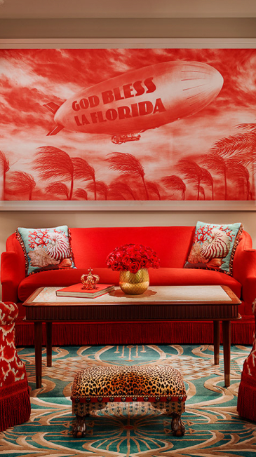 Red living room with a large mural of a blimp