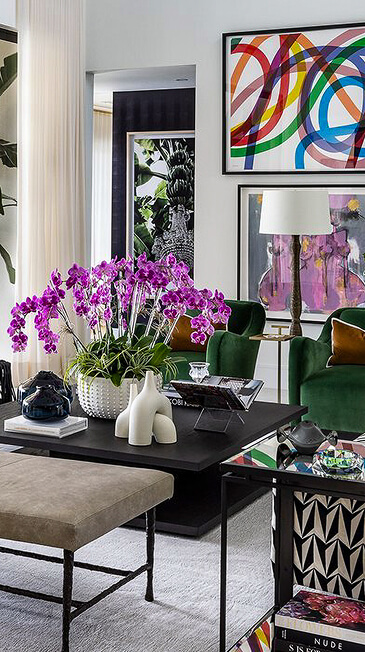 Living room with orchids and colorful framed art