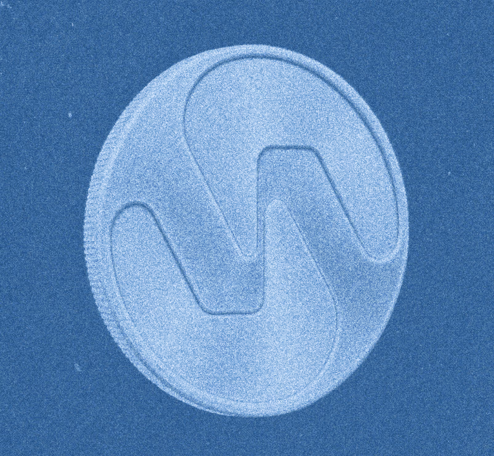 Close-up of a textured coin with a stylized wave-like design embossed on its surface set against a blue background.