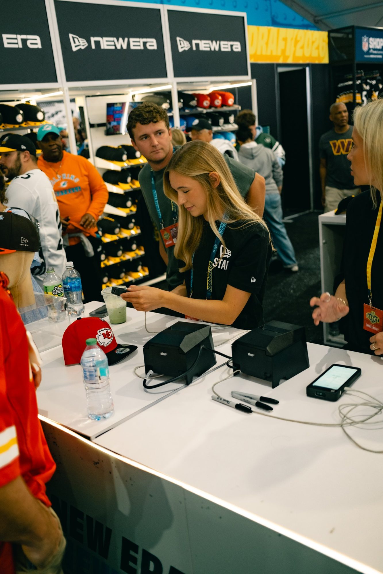 Staff ringing up customers at the New Era checkout