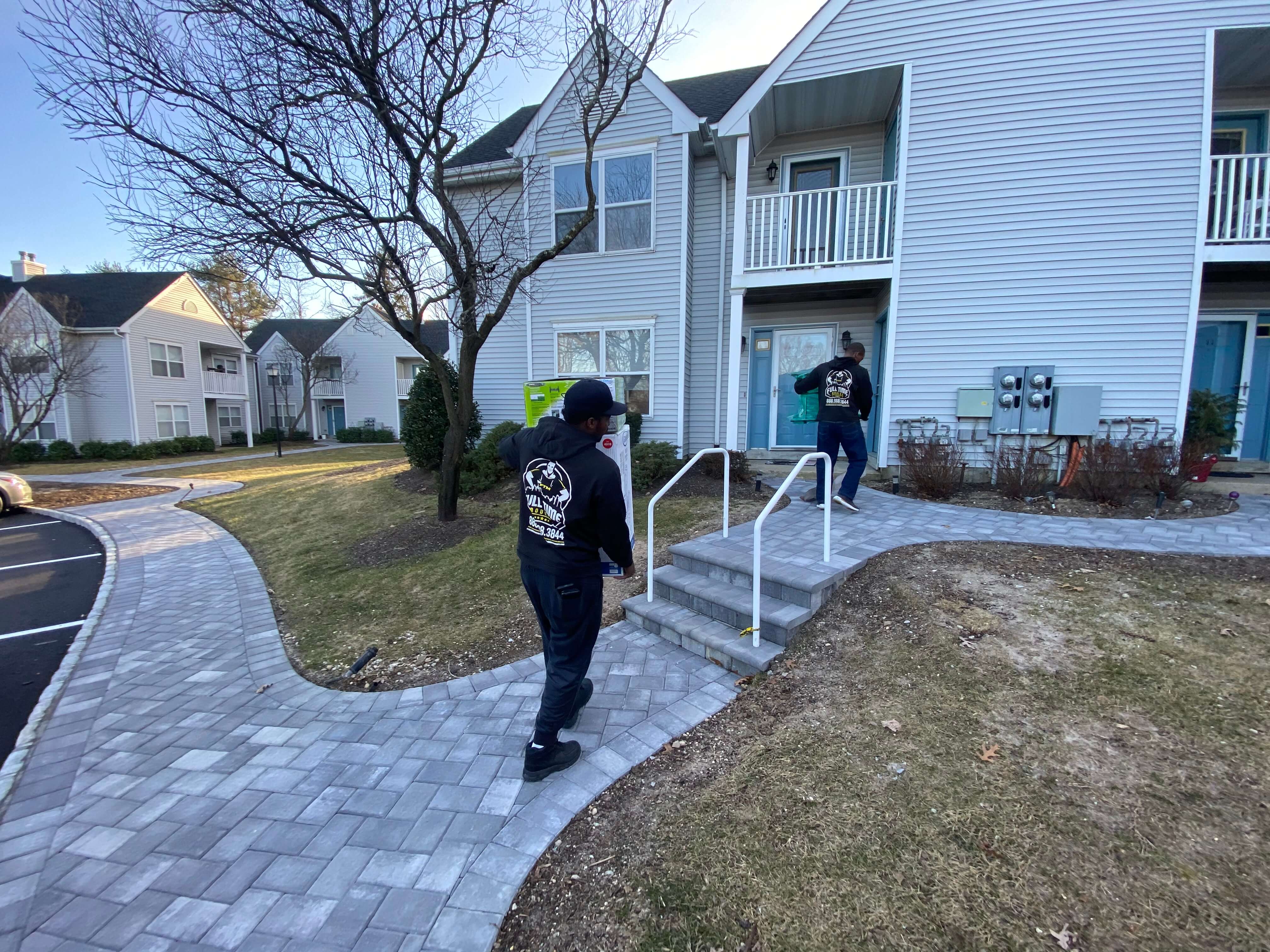 Full Time Movers crew walking to a townhouse entrance on moving day