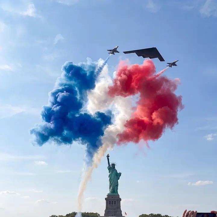 The same logo drawn in colored smoke at an air show