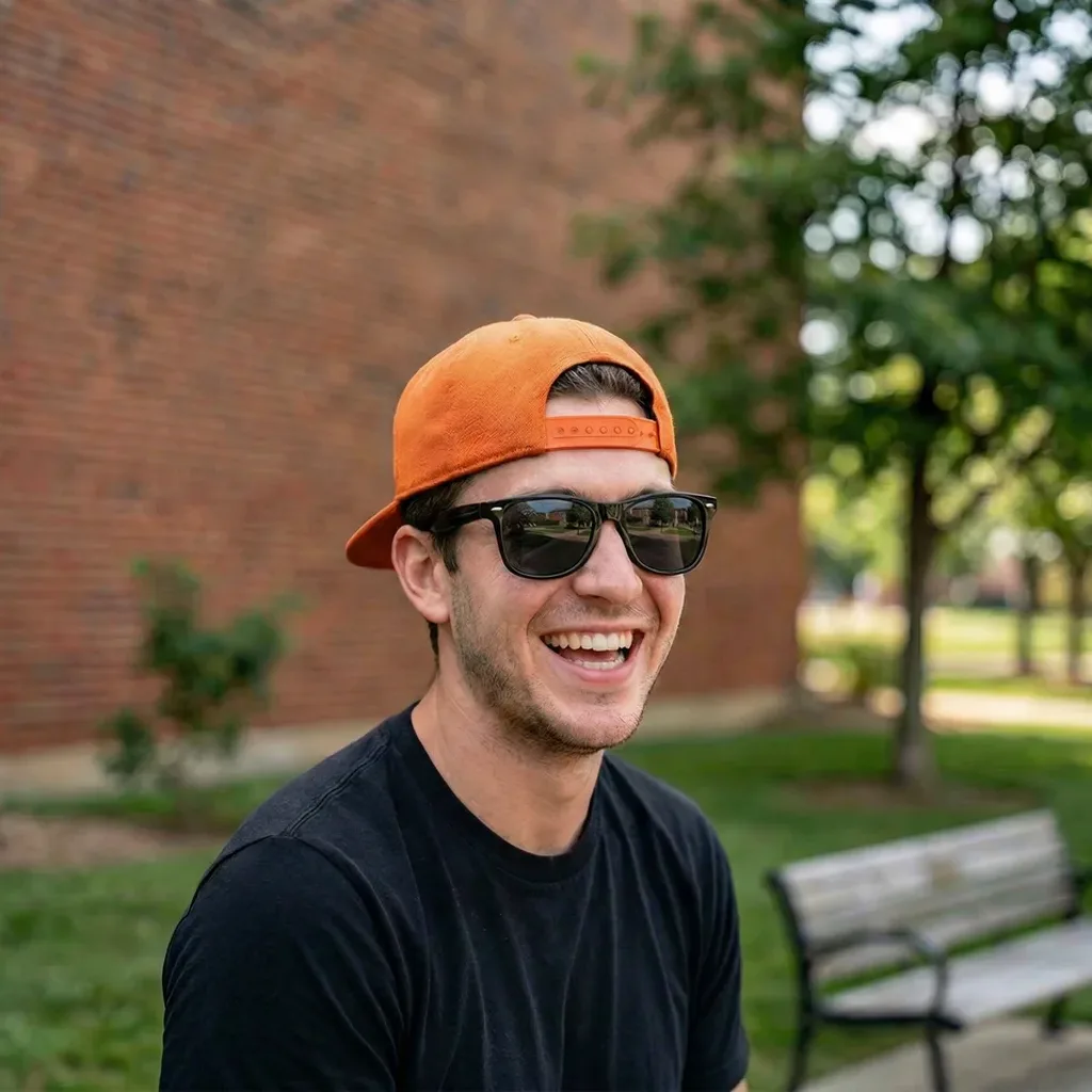 A man in a baseball cap and sunglasses photo