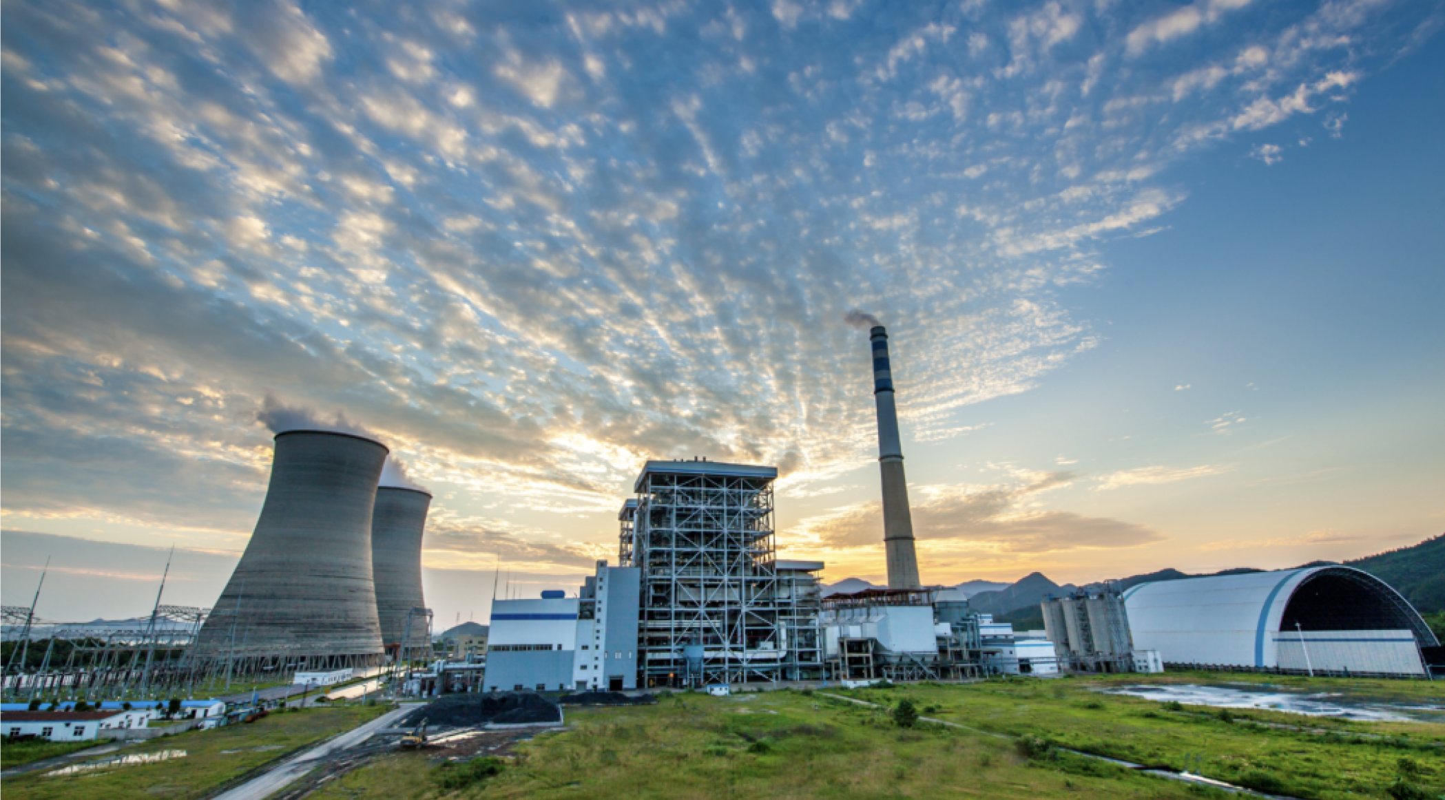 Power plant with cooling towers at sunset