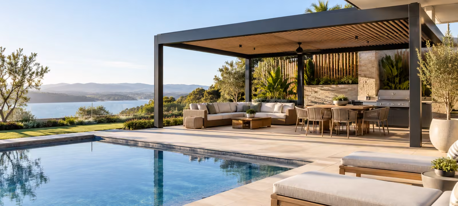 Backyard swimming pool beside a louvred pergola covering an outdoor lounge and dining area