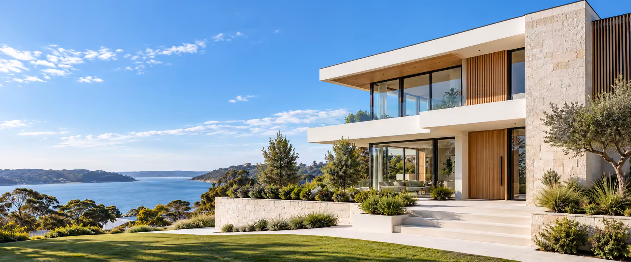 Modern two-storey home with stone and timber cladding and a landscaped lawn
