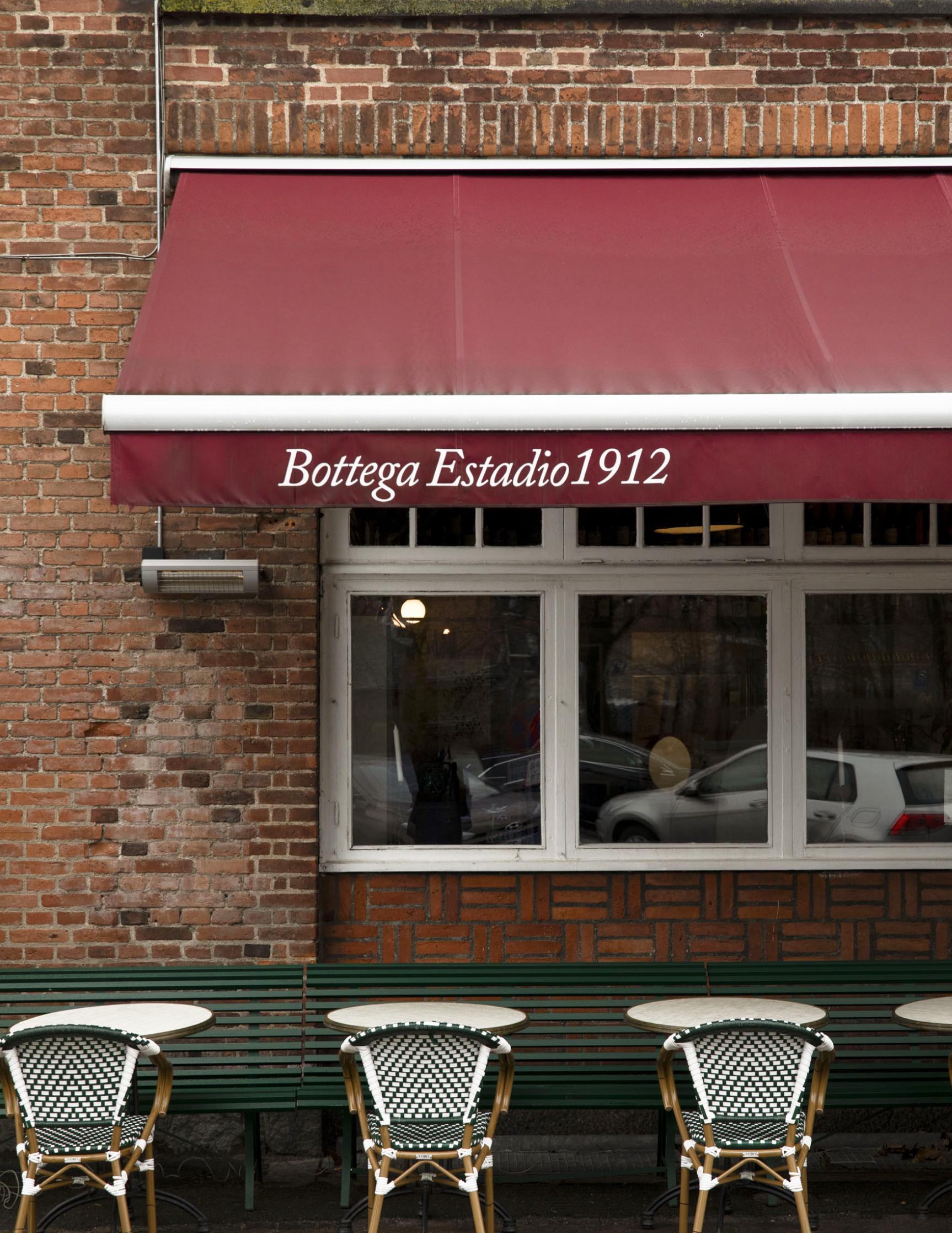 The Bottega Estadio 1912 facade with red awning