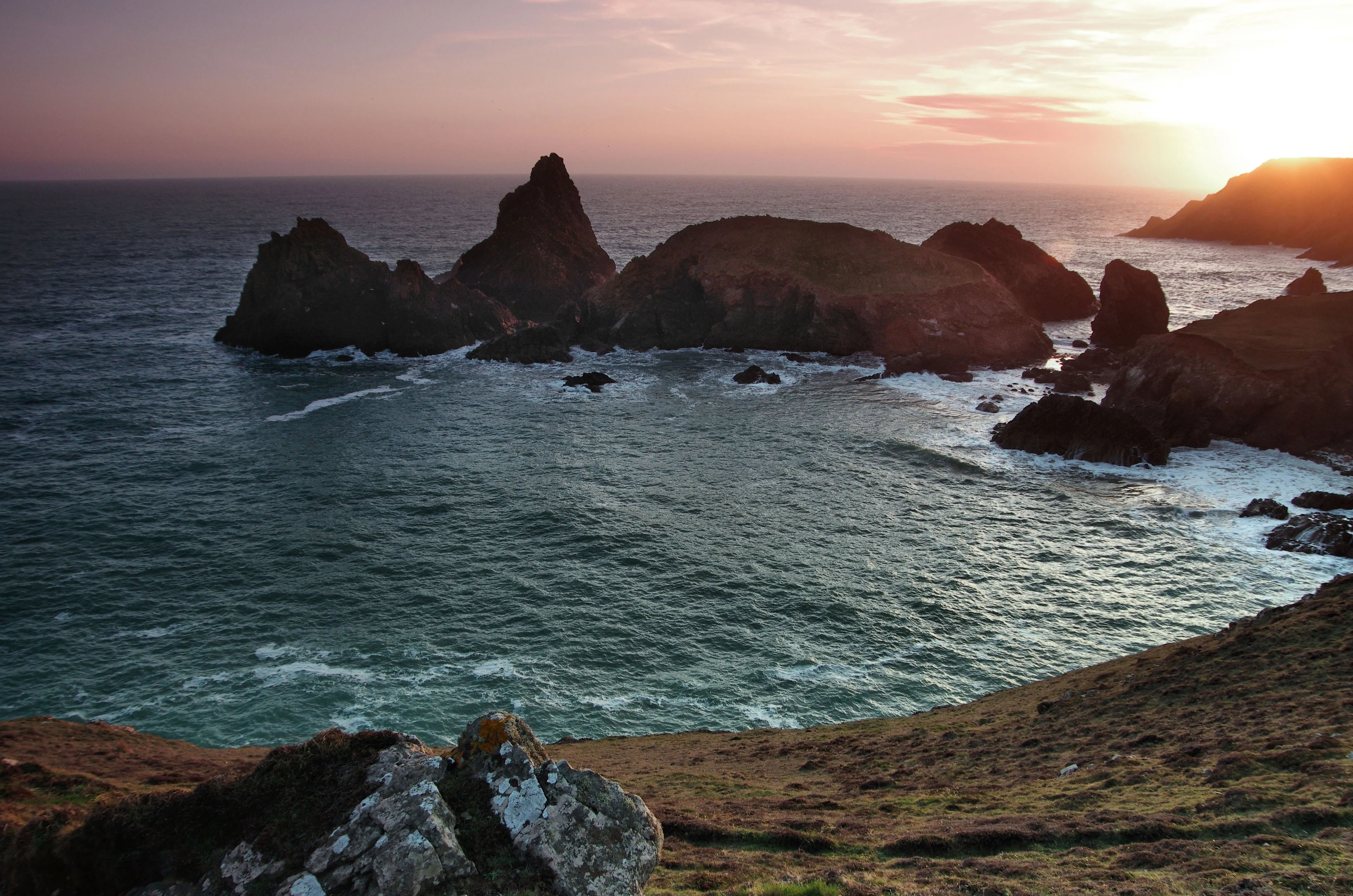 Rocky sea stacks and cove at sunset on the Cornish coast