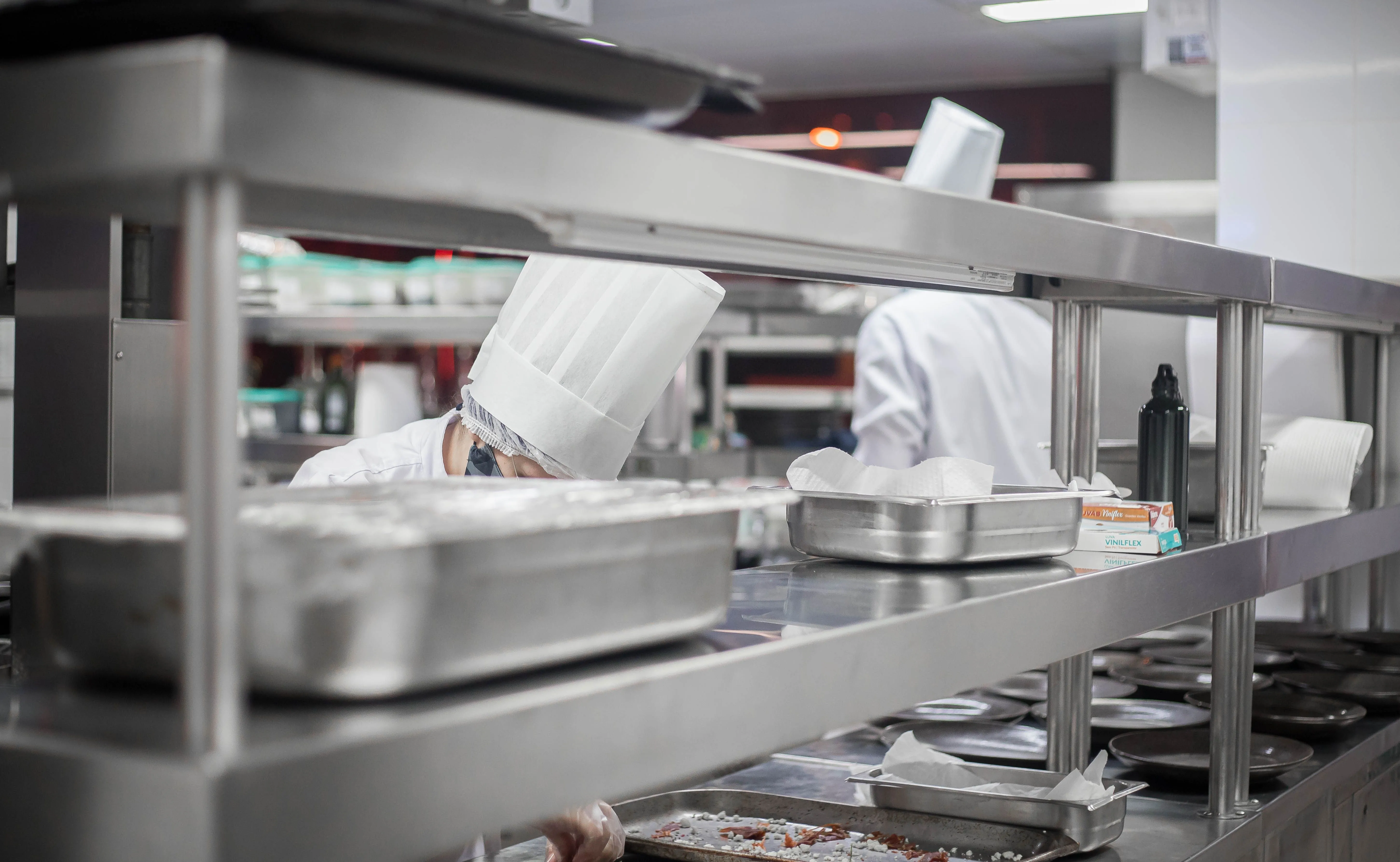 Busy commercial restaurant kitchen with chefs at work
