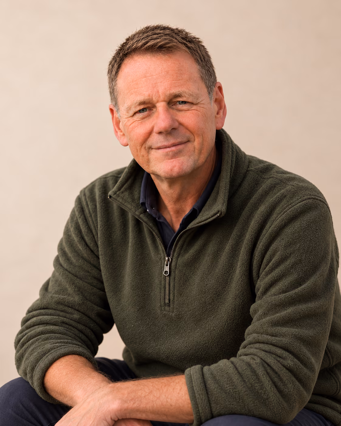 Michael, smiling, in an olive-green fleece