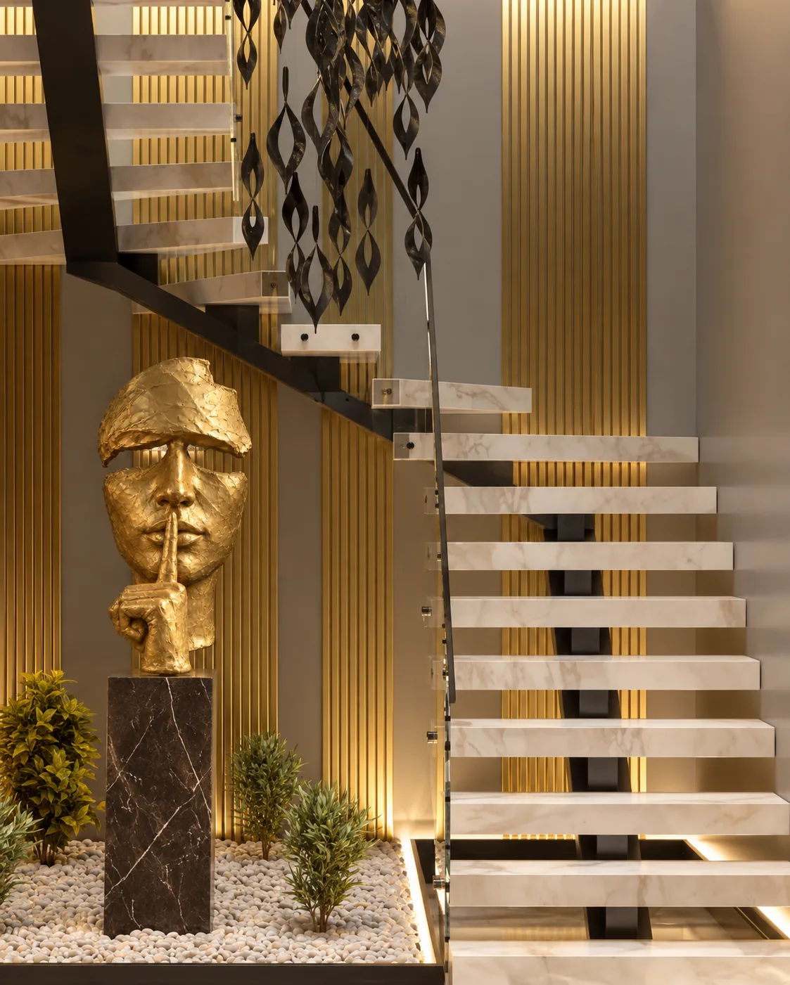 The Mask under the stair of a private home, on its Emperador Dark plinth, front view