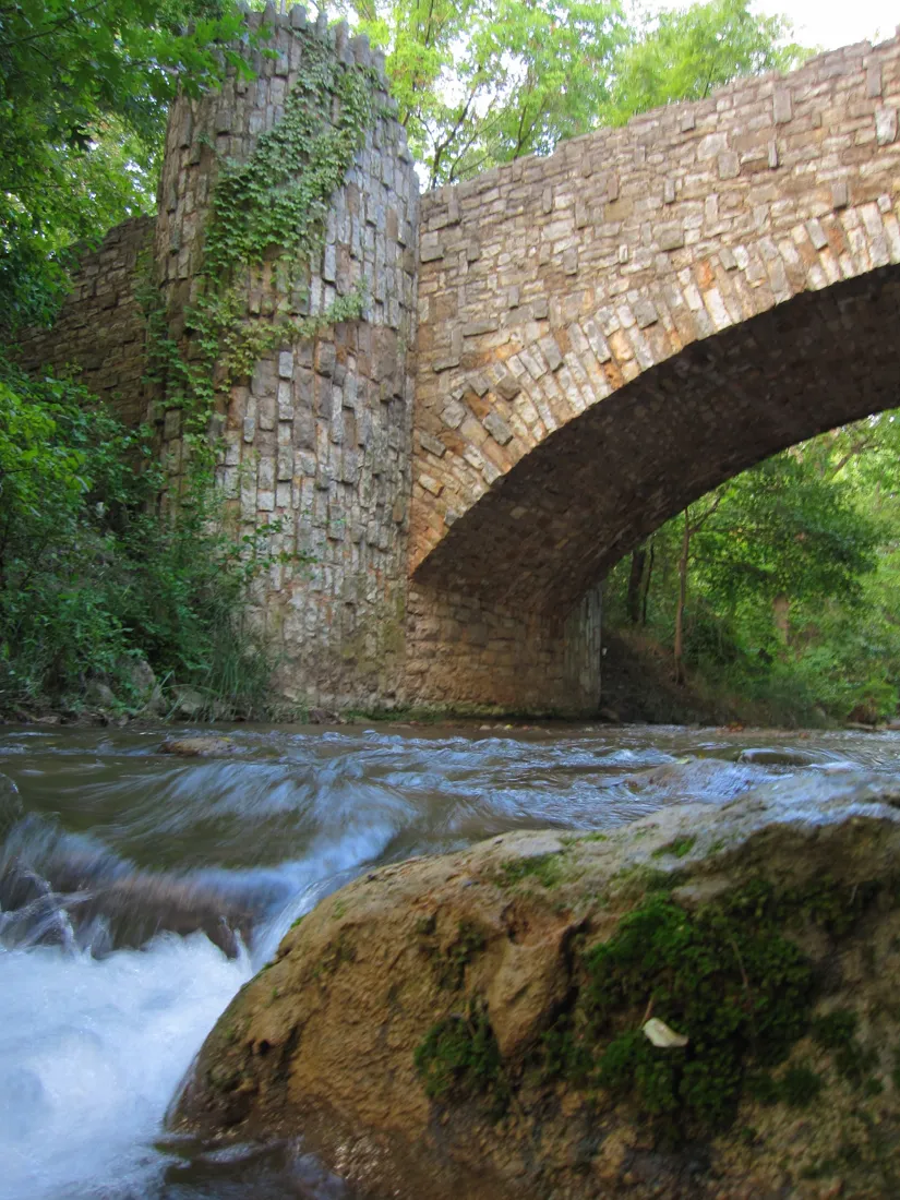 Travertine Creek flowing beneath Lincoln Bridge at Chickasaw National Recreation Area
