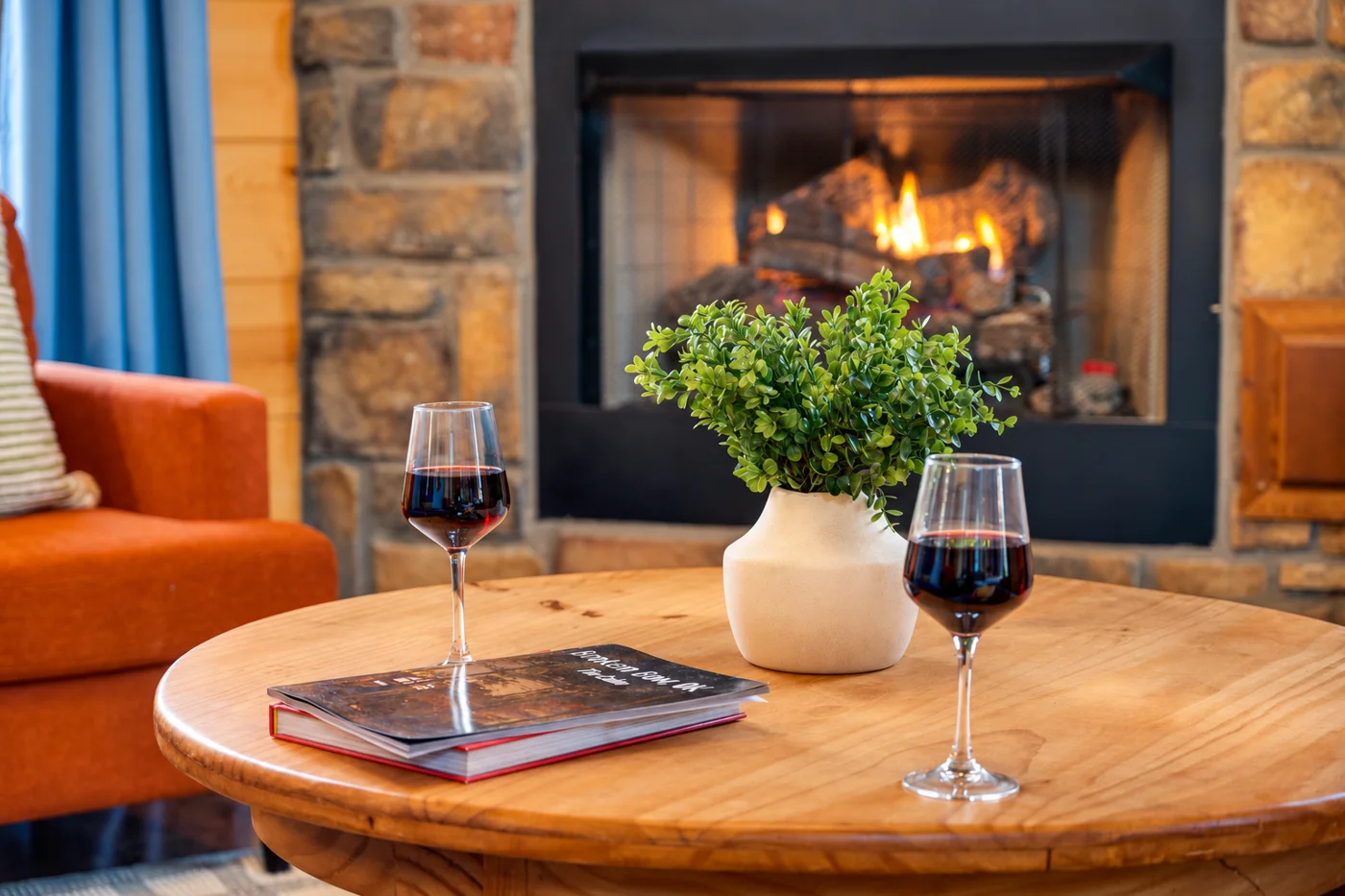 The indoor stone fireplace and seating at Hearth and Heritage