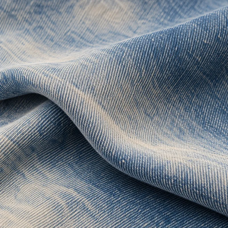Vintage blue denim with a subtle warm ecru tint in its faded fibres.