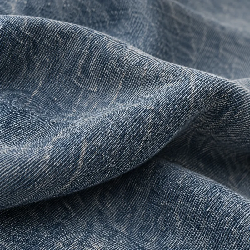 Vintage denim with a muted smoky blue cast and softly worn areas.