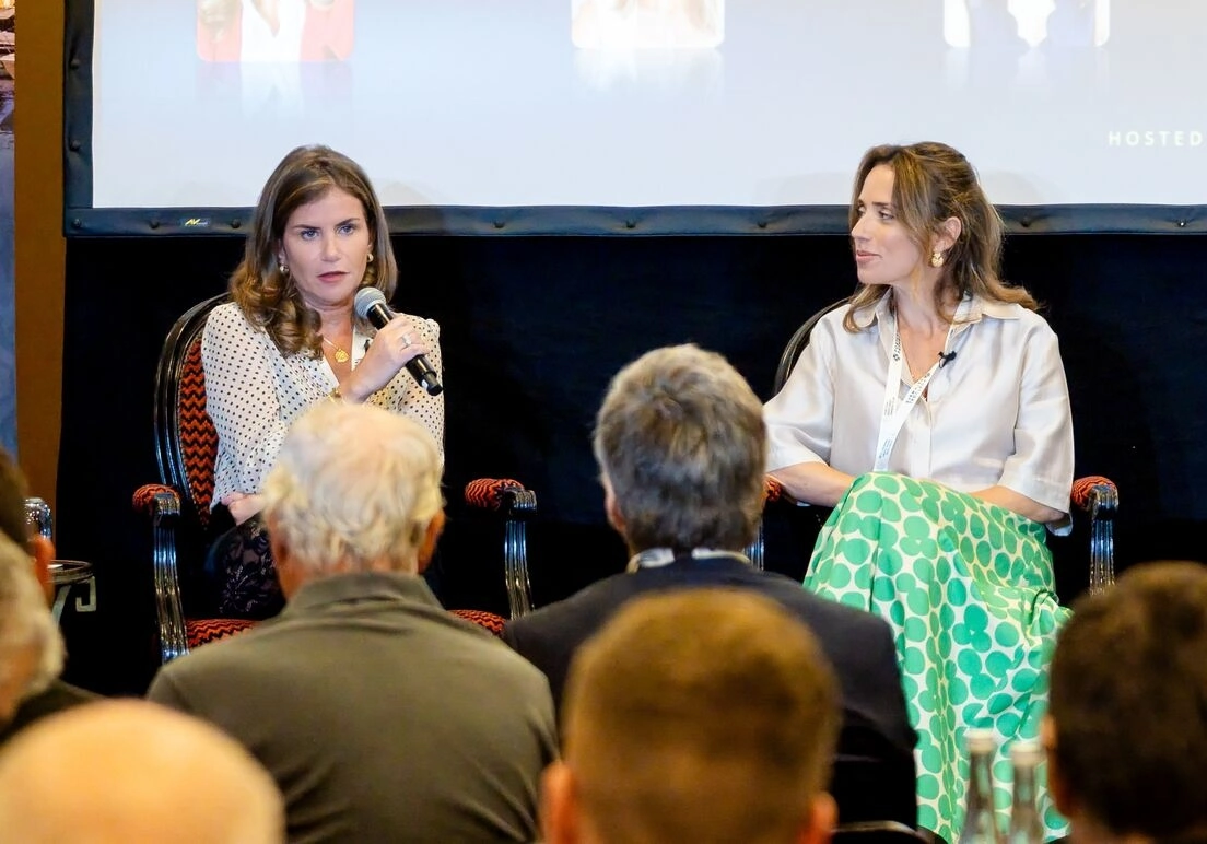 Two panellists discuss luxury markets before an attentive seated audience