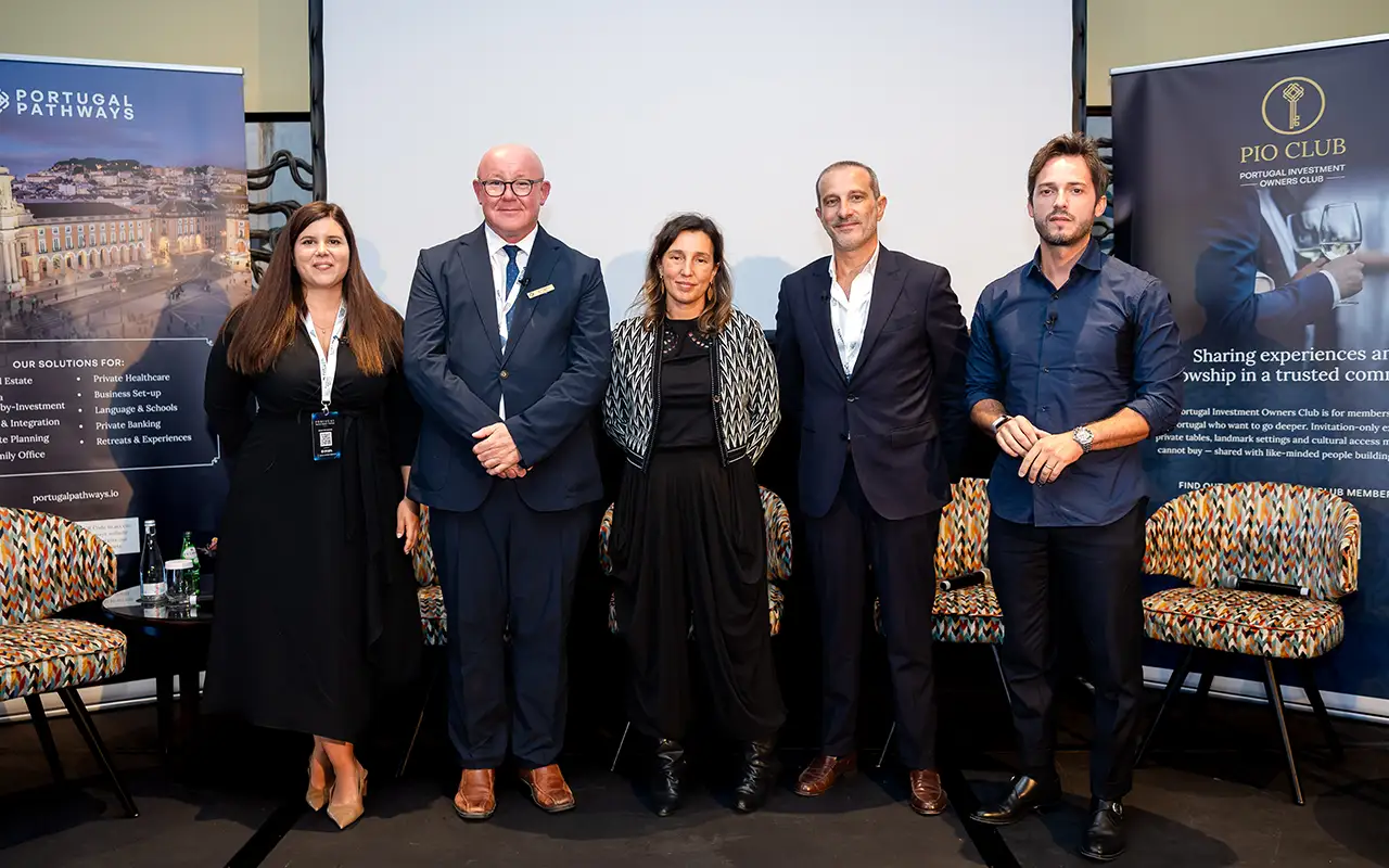 Five panellists pose together following their session on stage