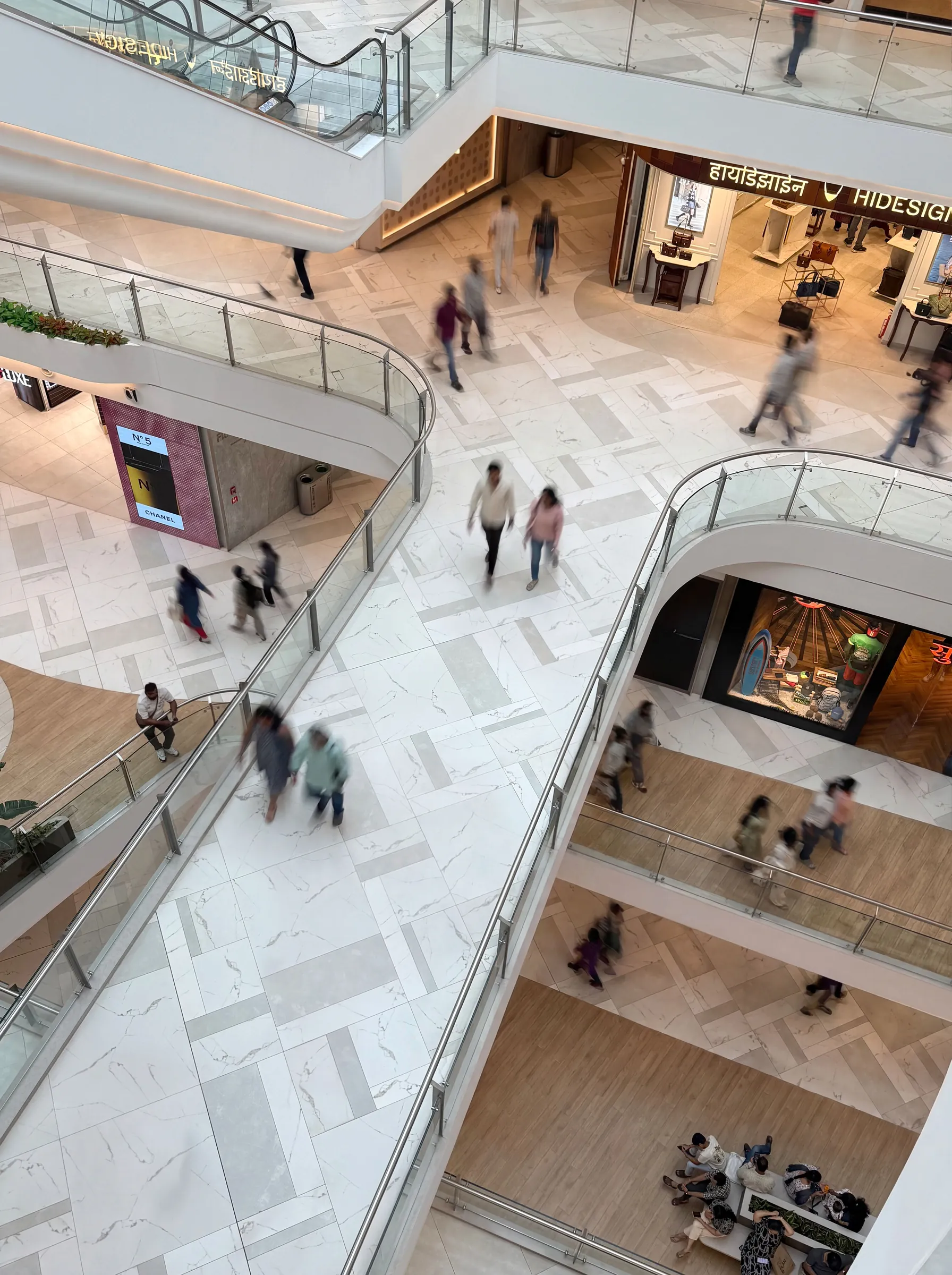 View down through the SkyCity Mall atrium to shoppers on the patterned stone floors below