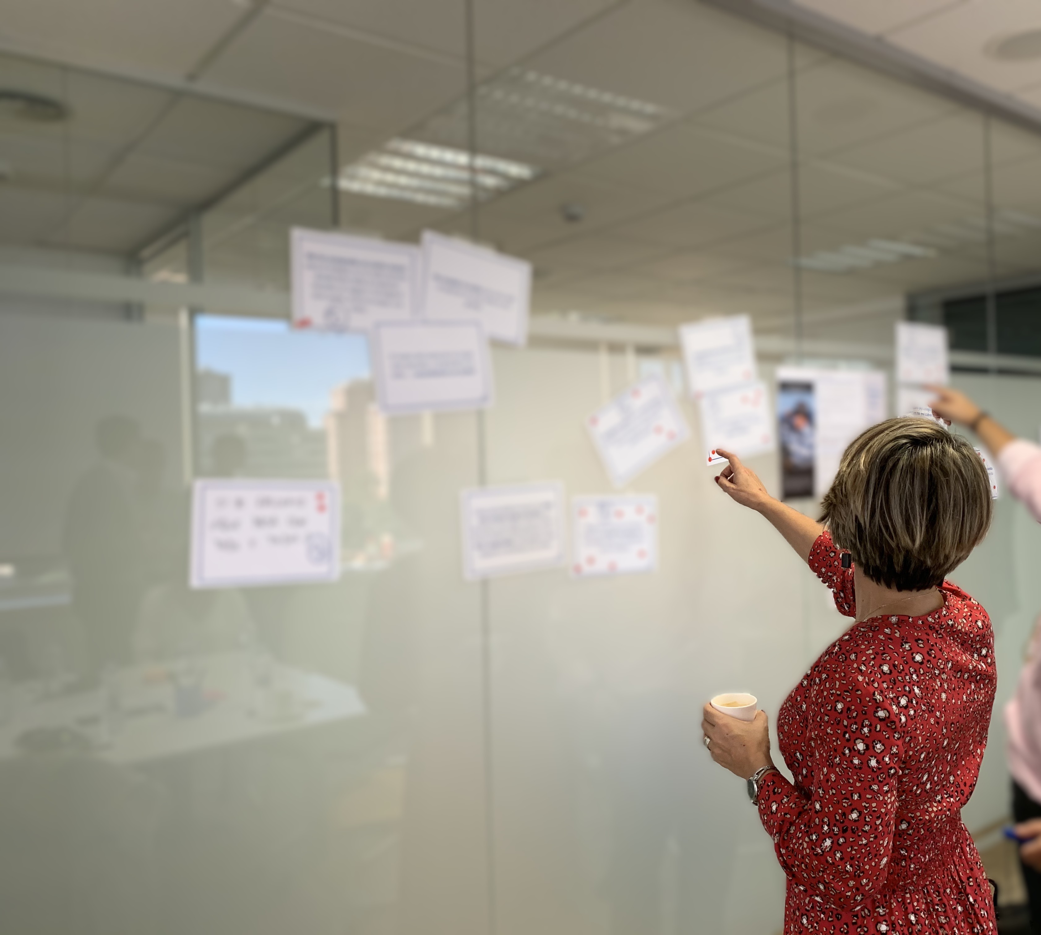Sonia facilitating a strategy workshop at a glass wall