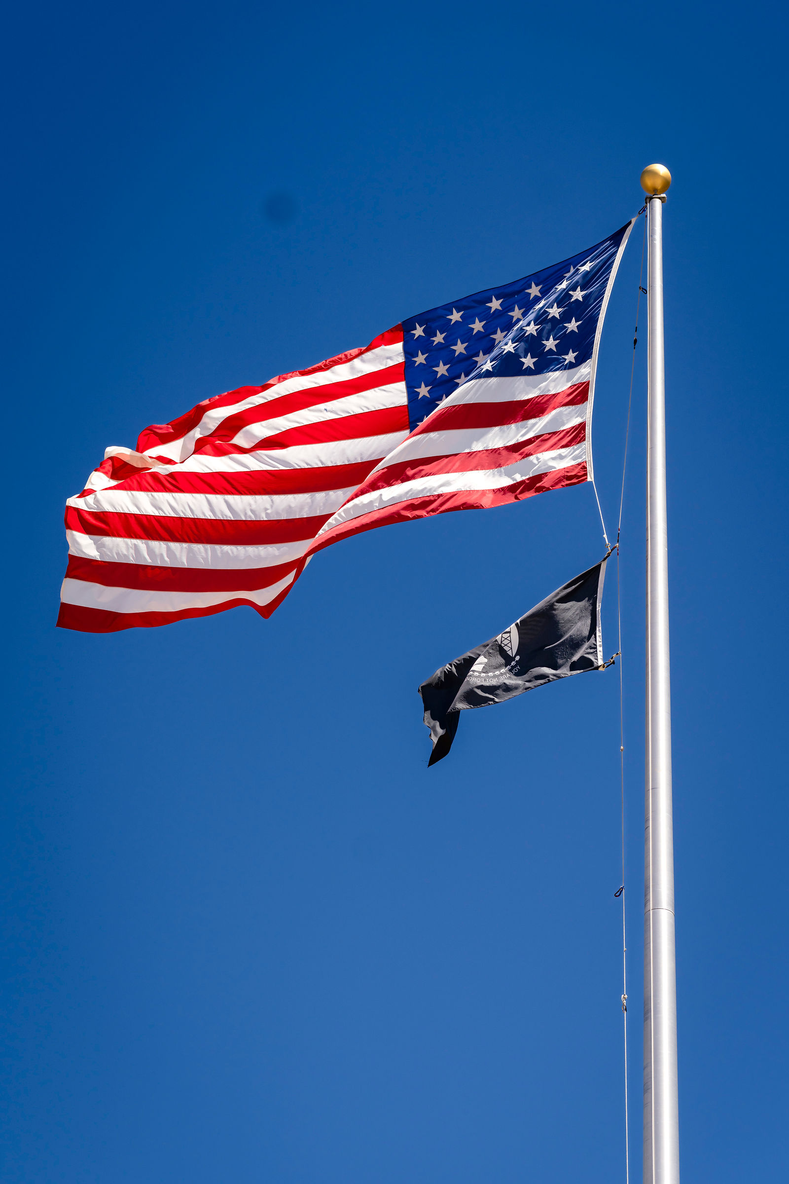 The American flag against a clear blue sky at the ceremony