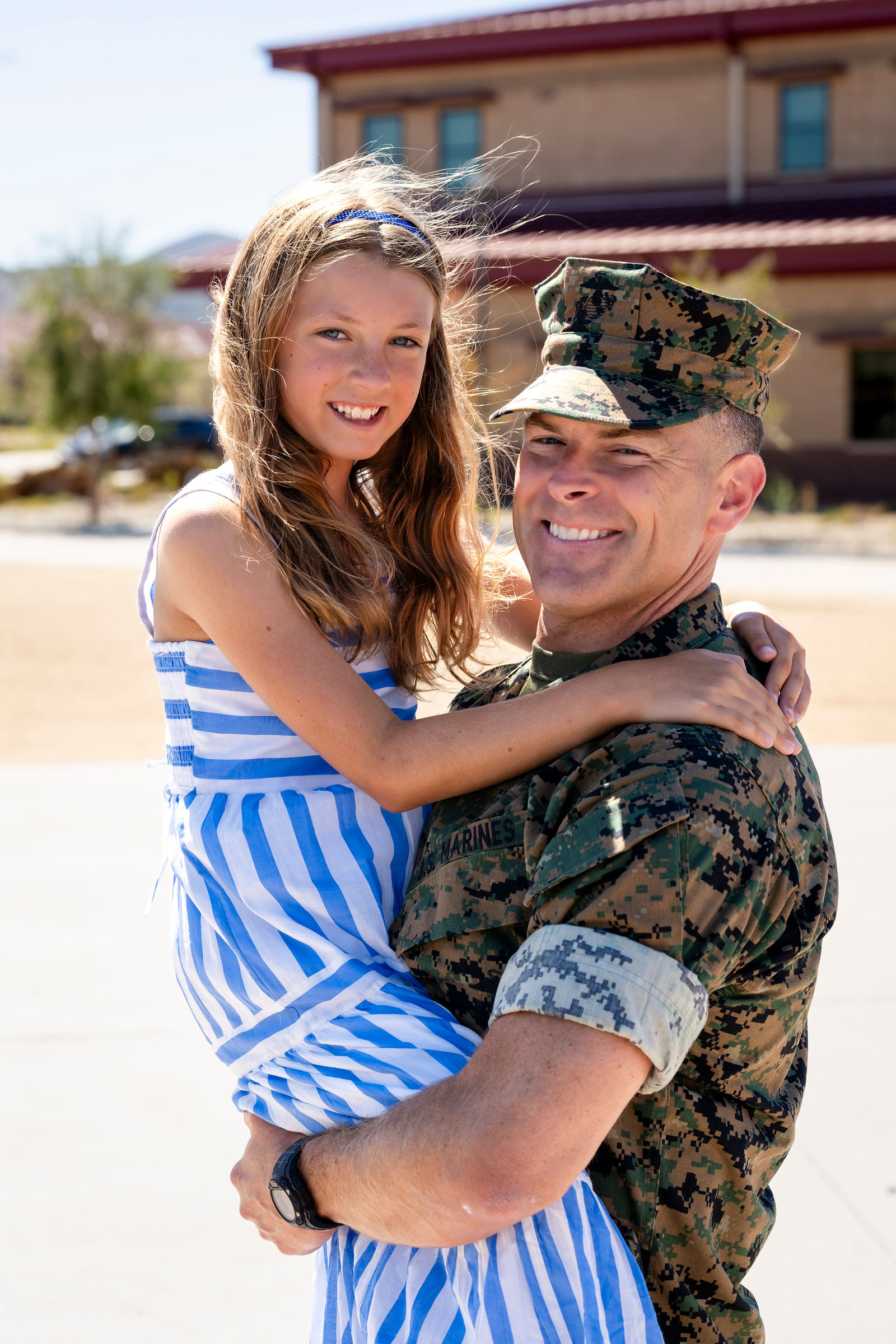 Colonel Eric Skoczenski lifting his daughter in an embrace