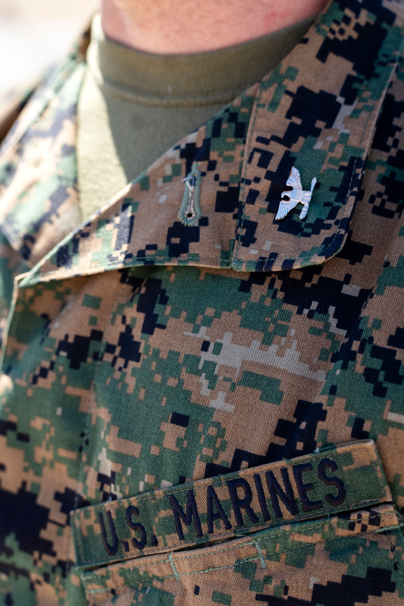The Marines name tape and insignia on his uniform