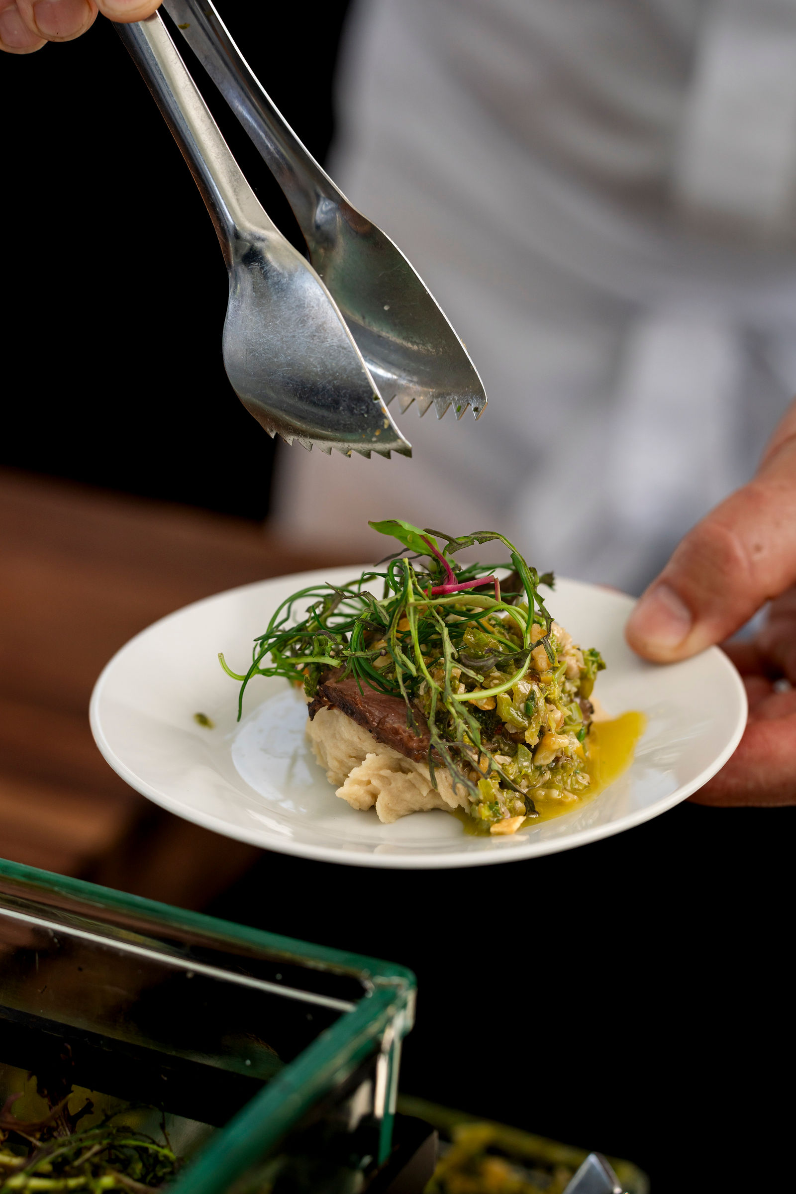 A plated dish being finished