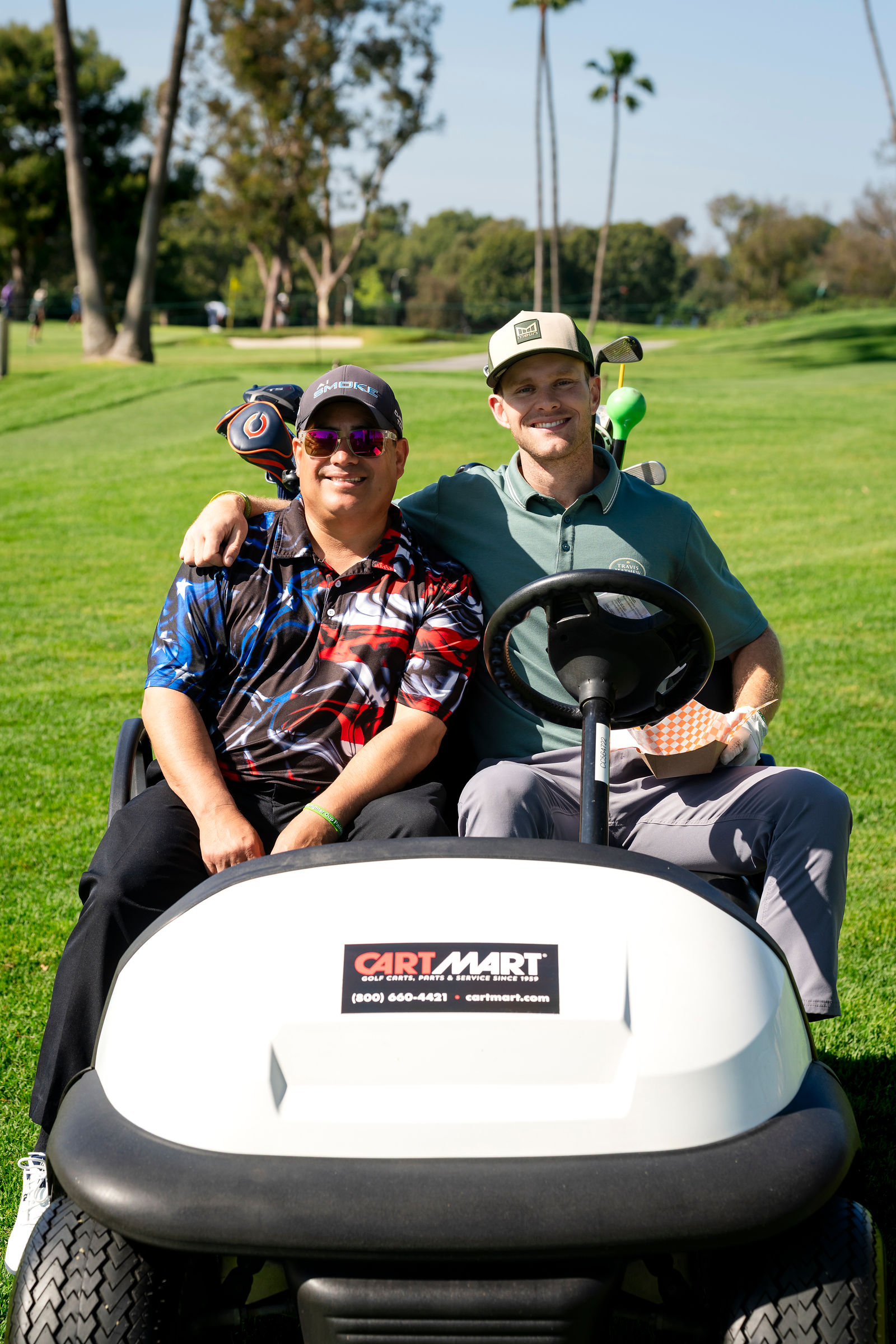 Players in a golf cart