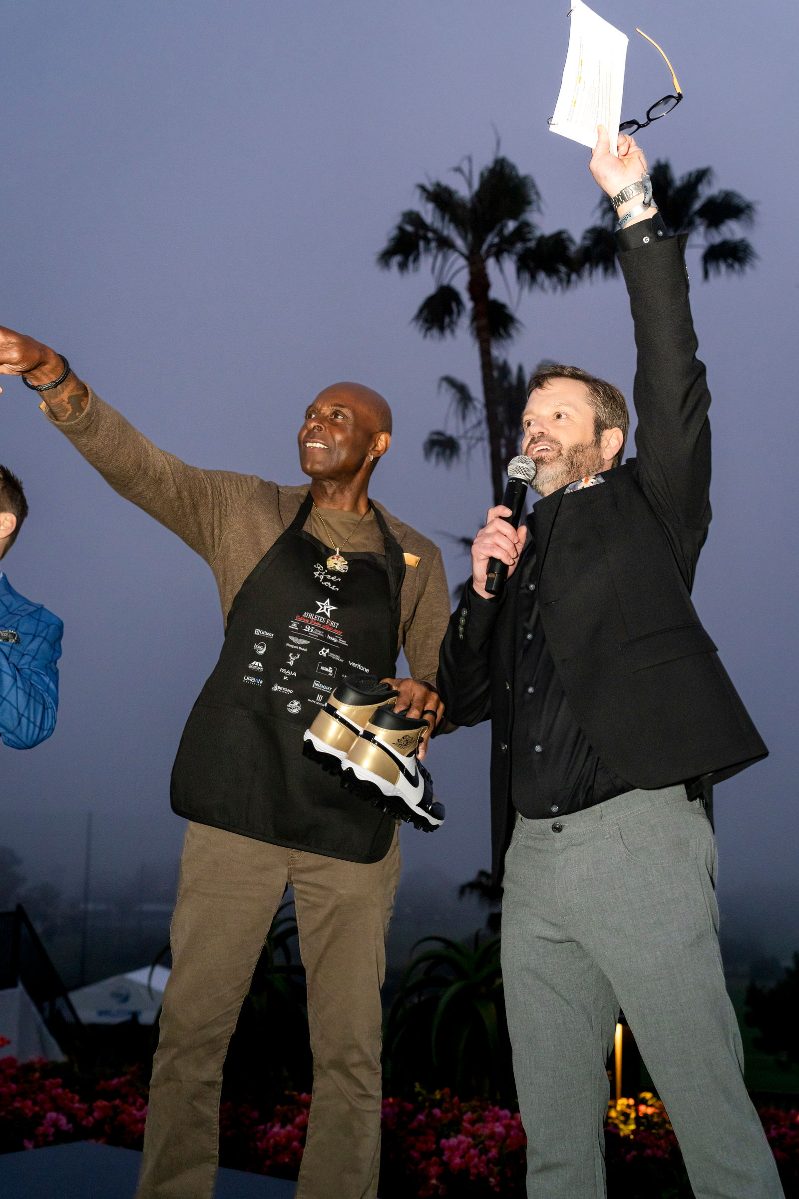 Athletes on stage at blue hour during the auction