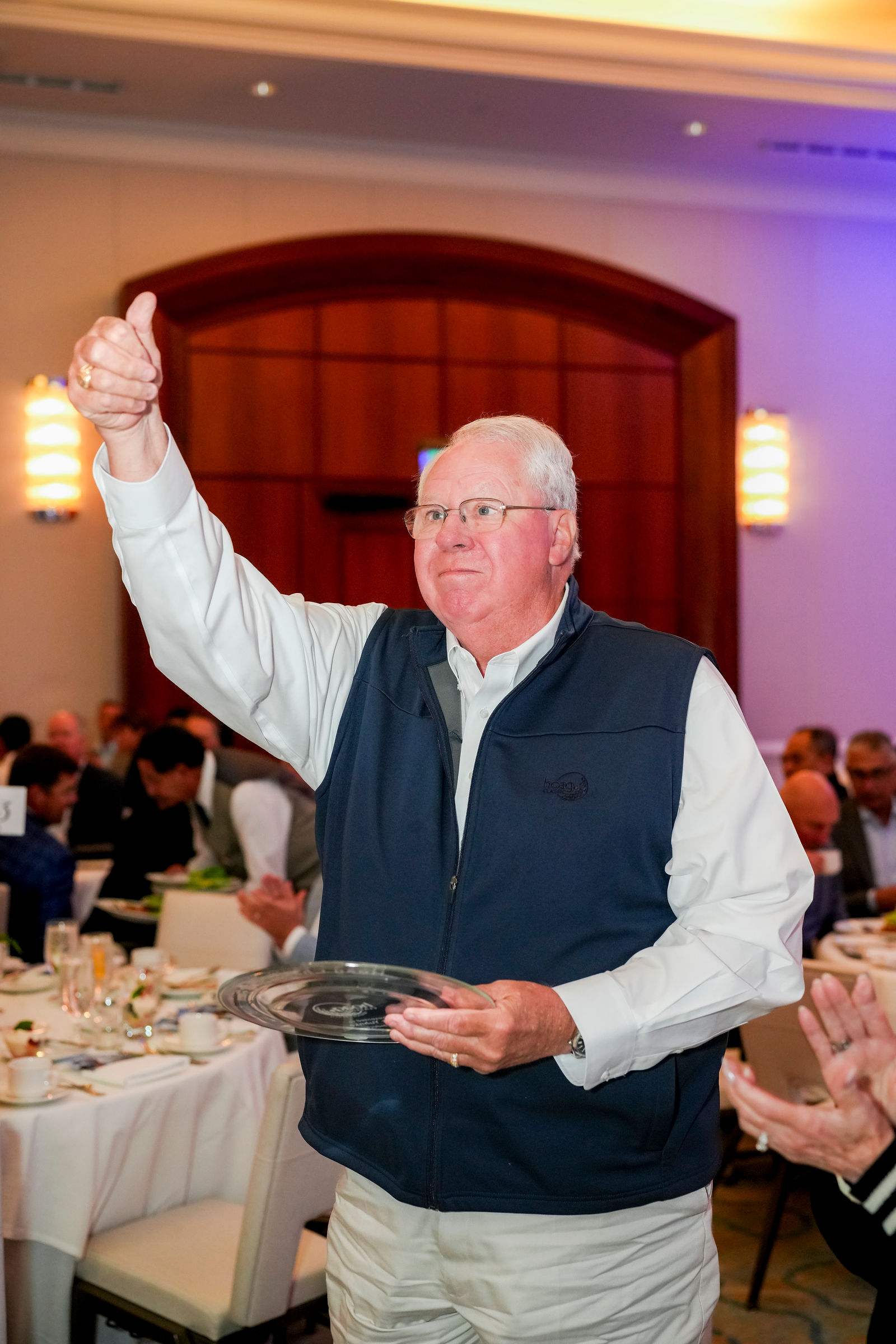 A guest raising his hand in celebration at the breakfast