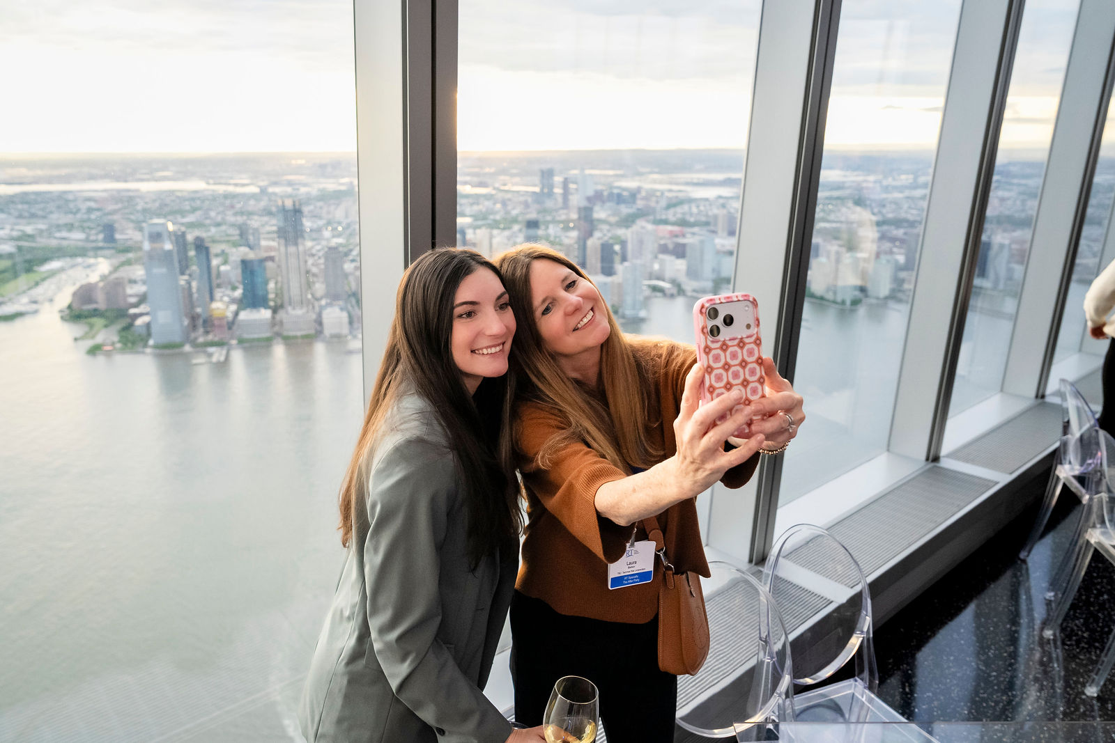 Two guests taking a selfie against the view high above New York City