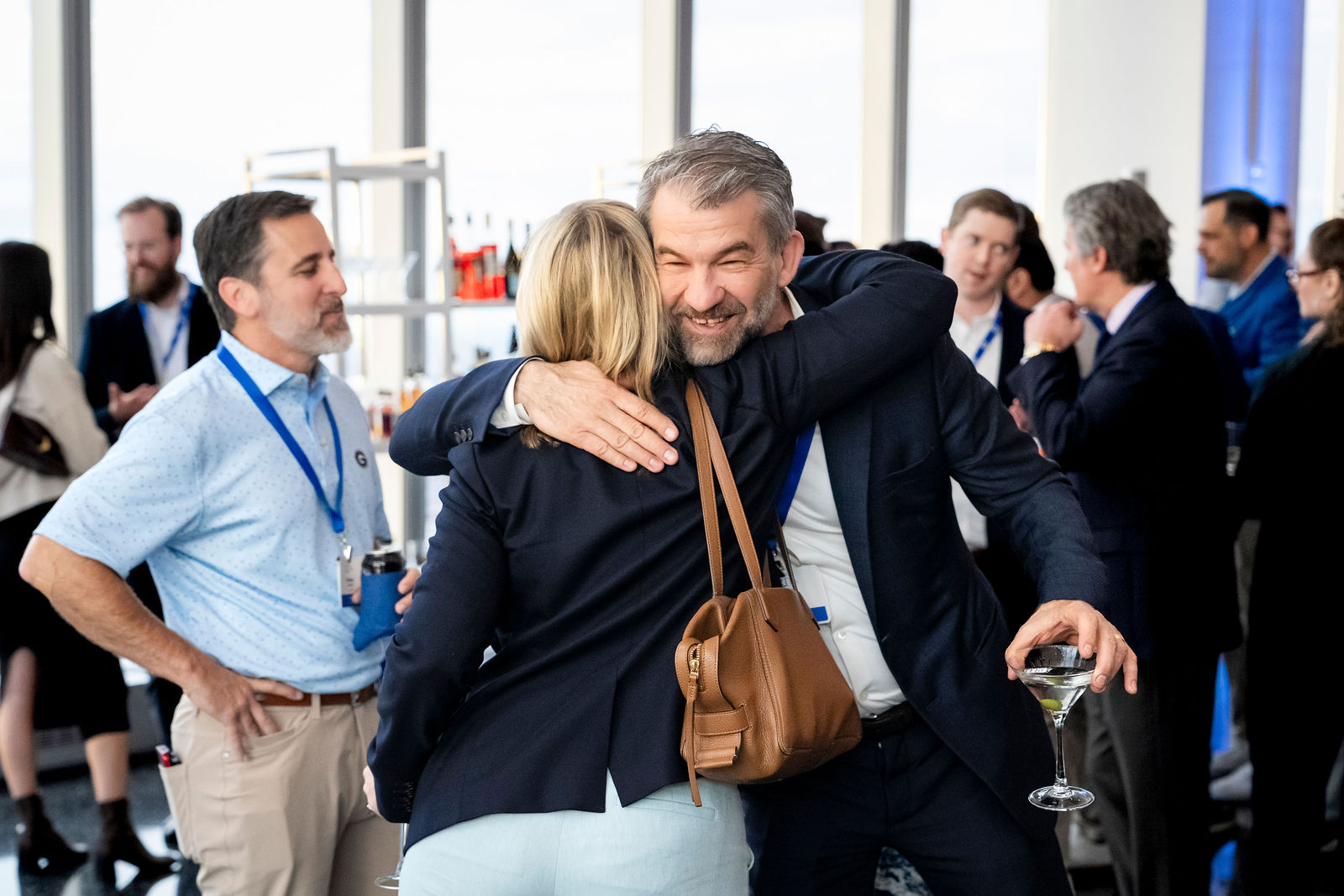 Guests greeting each other with an embrace at the after party