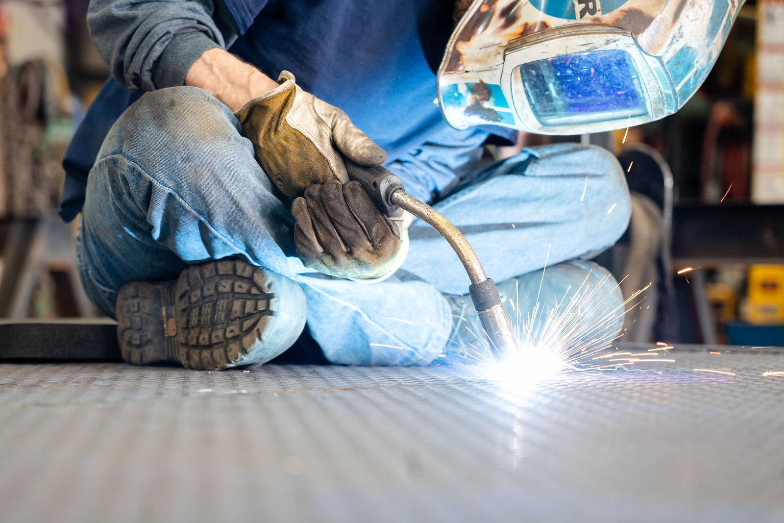 A welder throwing sparks on the shop floor at Hews