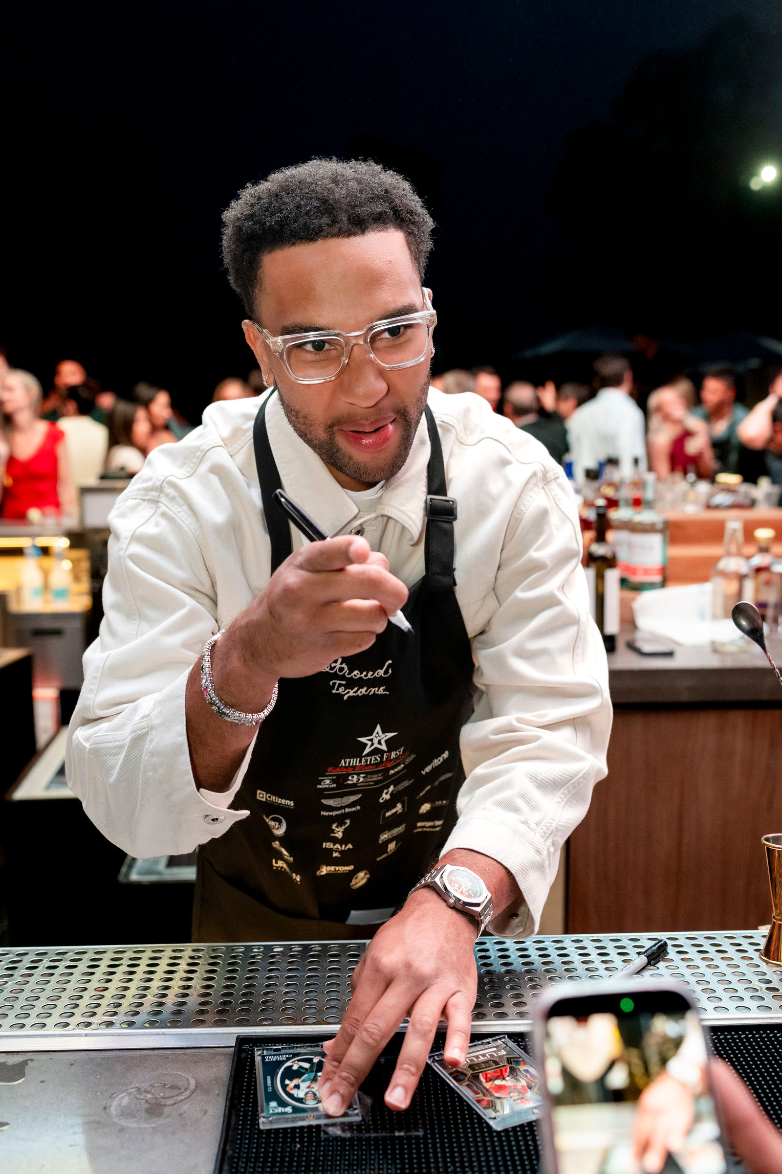 C.J. Stroud serving behind the bar at Celebrity Waiter Night