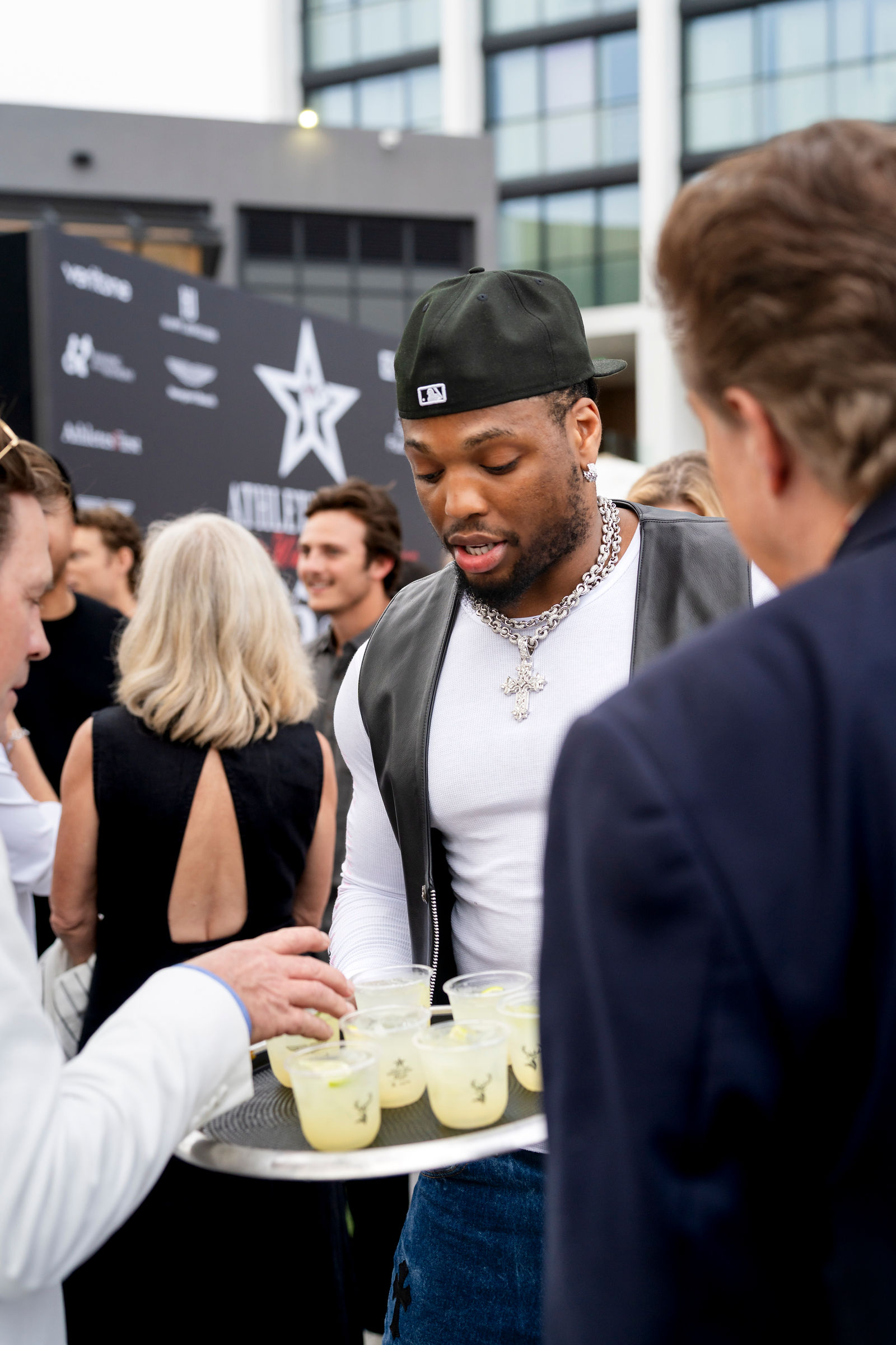Derrick Henry serving drinks to guests