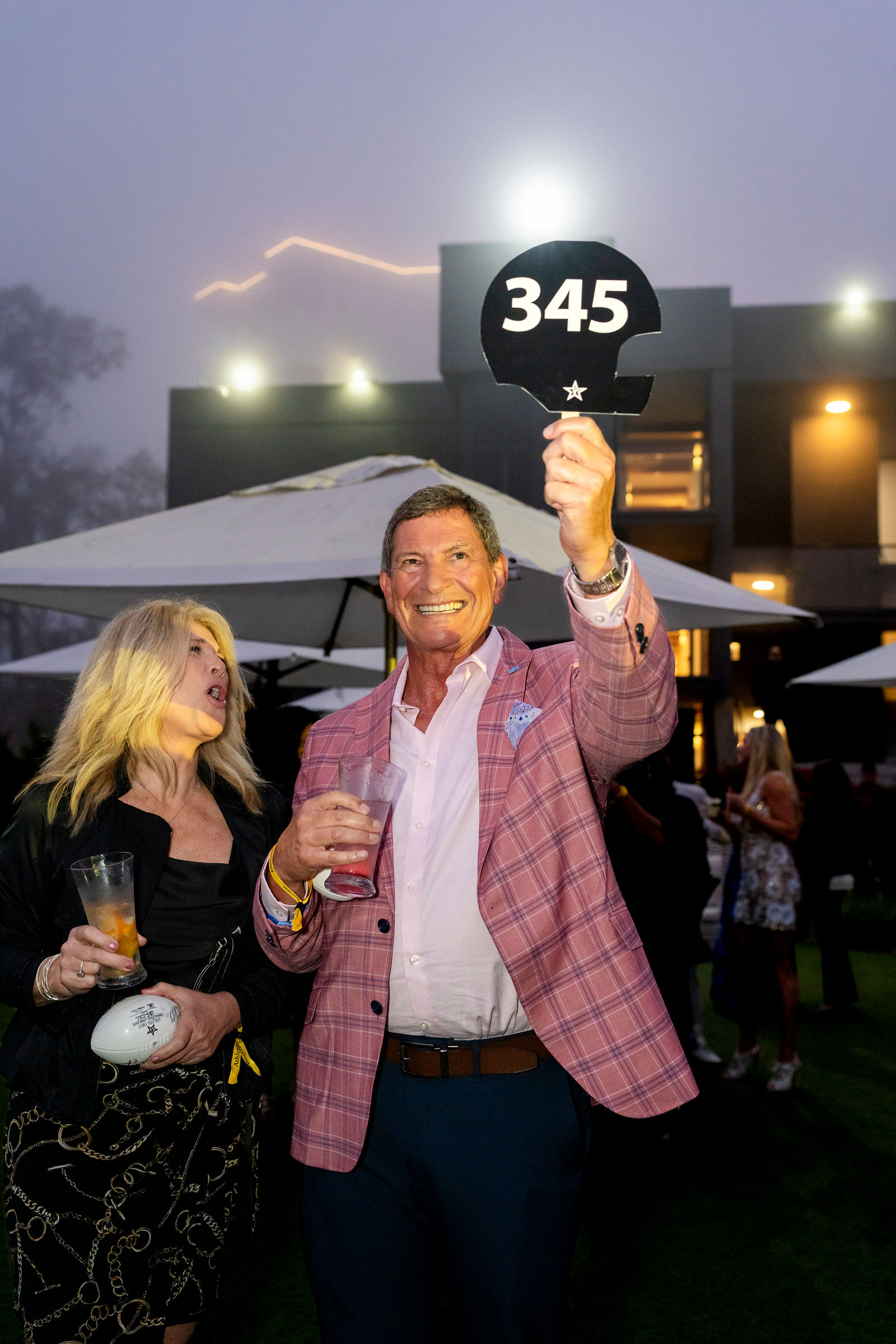 A guest raising a bid paddle during the live auction