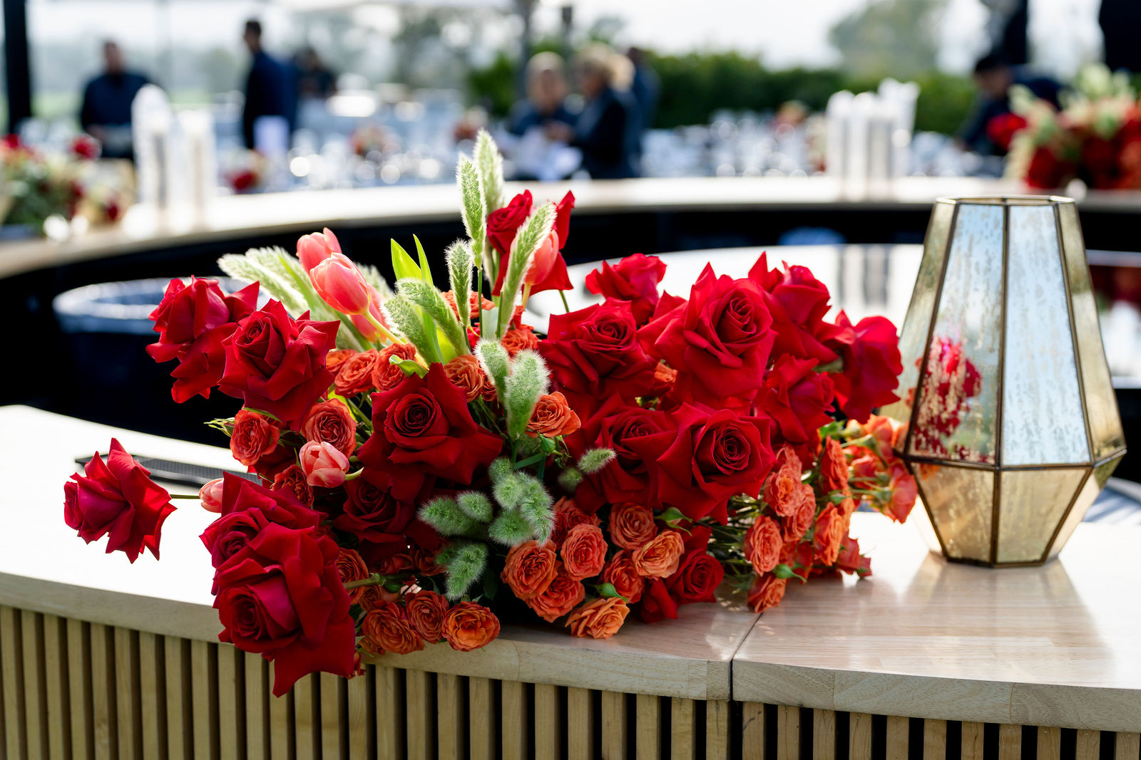 A floral arrangement of red roses on the bar