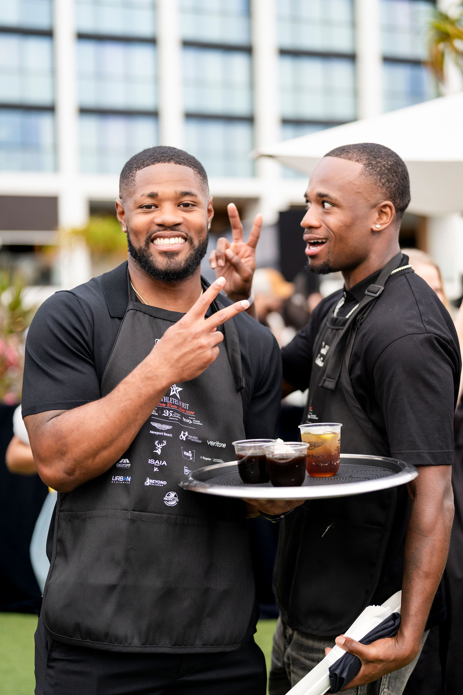 Two athletes with a tray of drinks