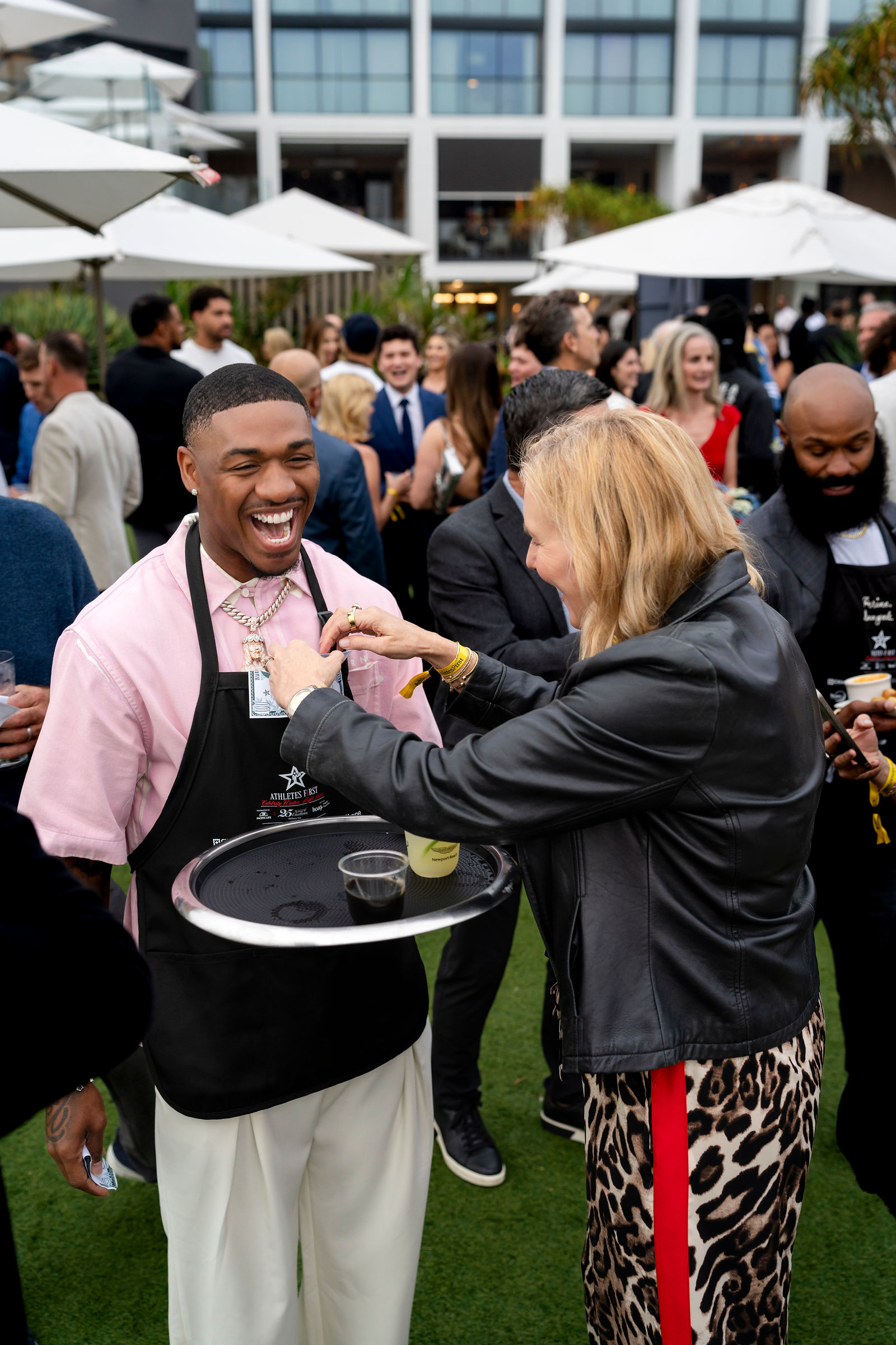 A guest sharing a laugh with an athlete